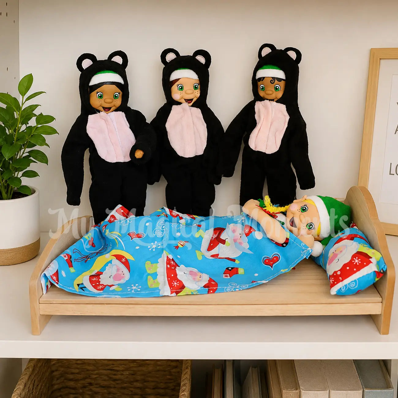 3 elves wearing bear costumes playing out goldilocks in bed