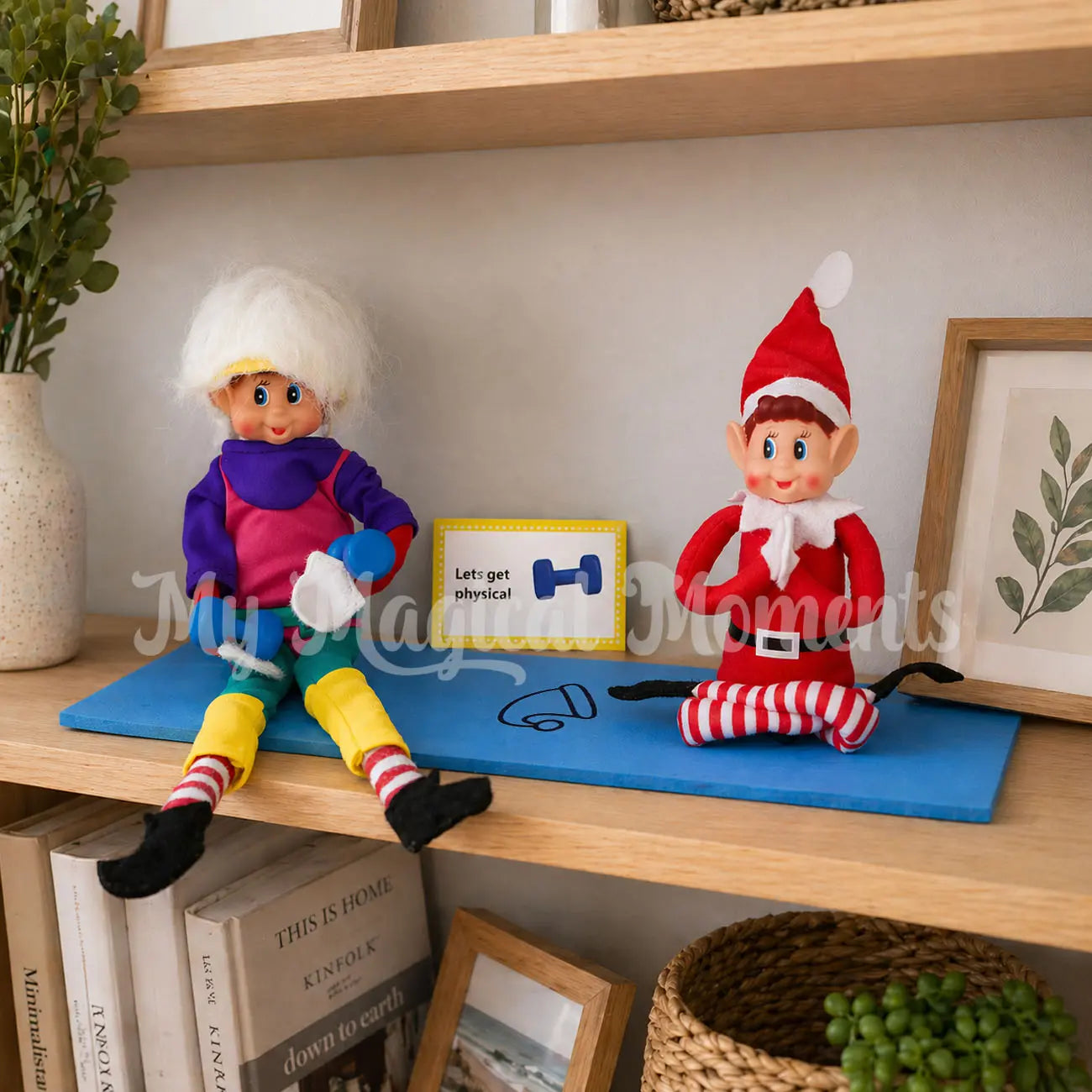 elf wearing a workout costume with mini dumbbells on a yoga matt with an elf doing yoga
