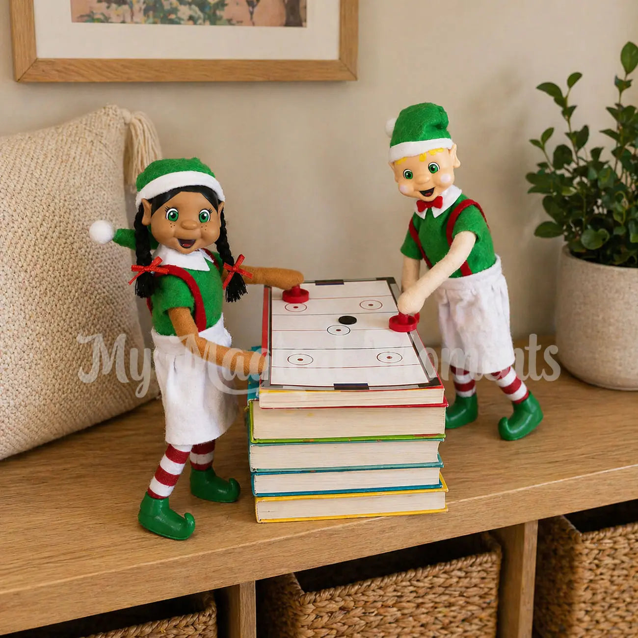Bendable standing Elves playing air hockey on a bunch of books.