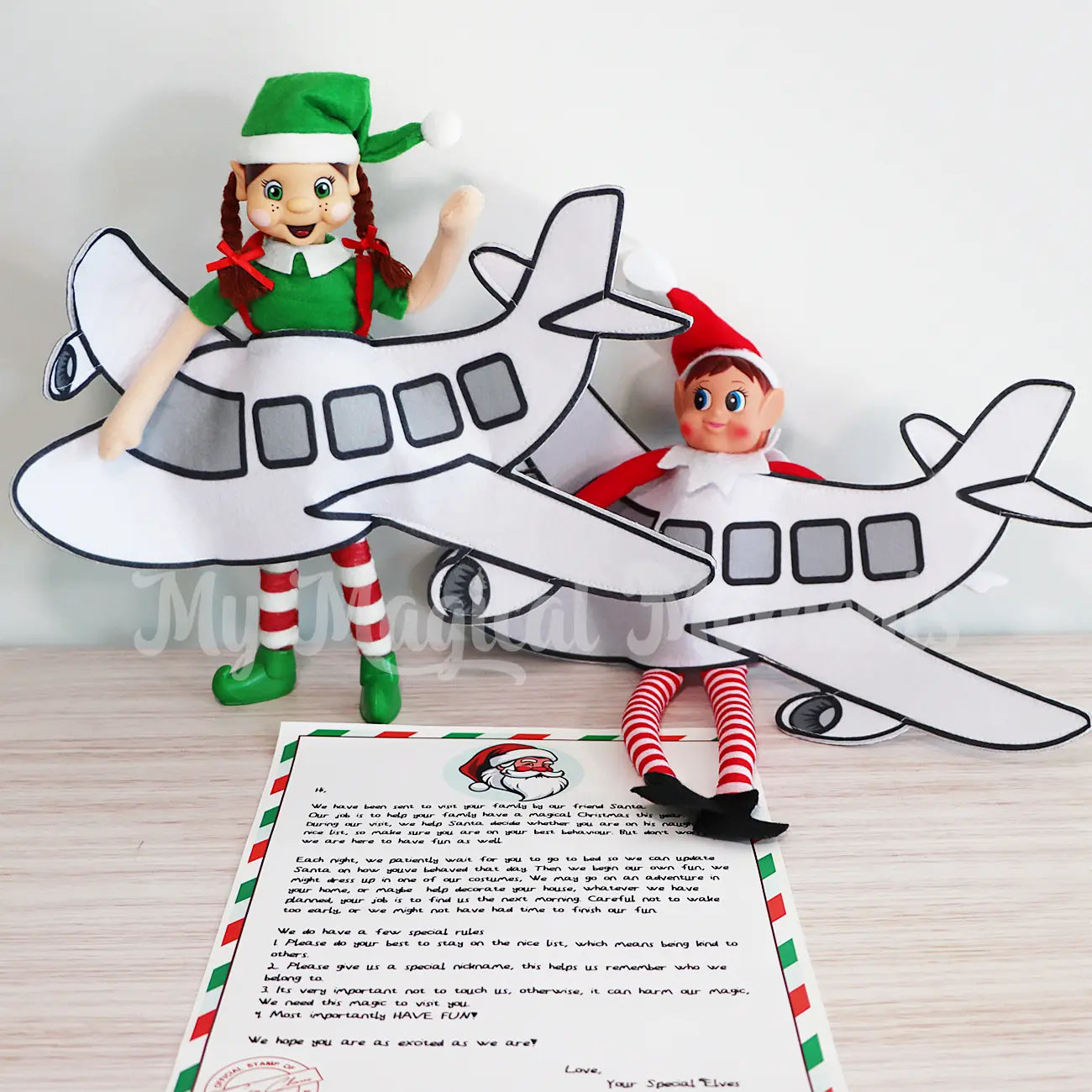 Elves wearing an airplane costume with an arrival letter printable