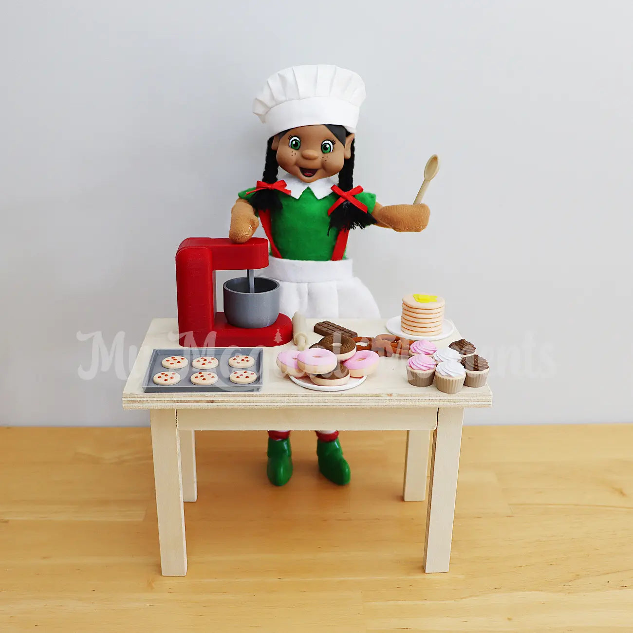 Elf baking with mini elf food, donuts, cupcakes, pretzels, pancakes, chocolate and mini cookies
