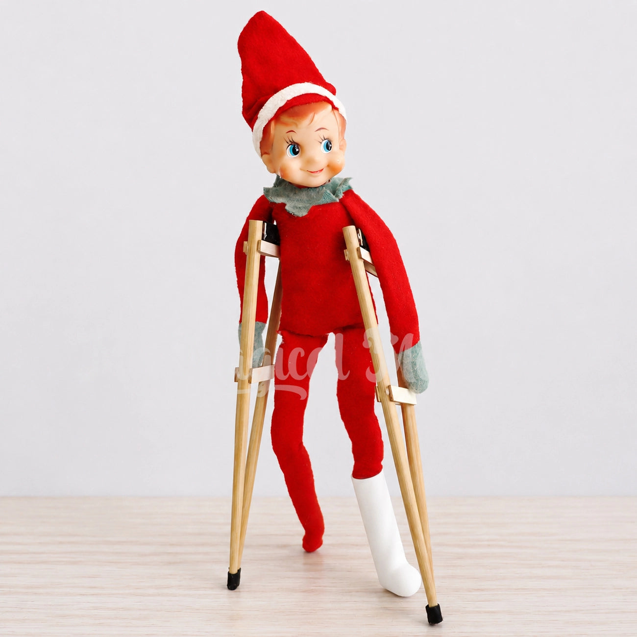 Vintage elf using elf sized crutches and a miniature leg cast