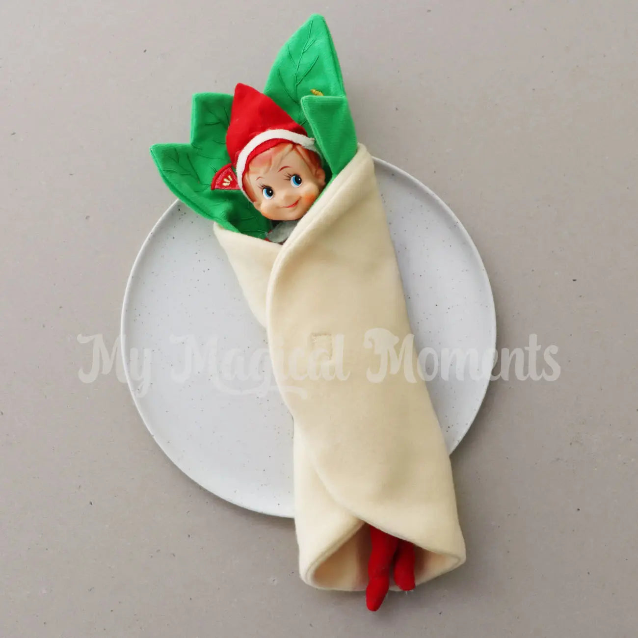 Elf dressed in a burrito costume on a plate