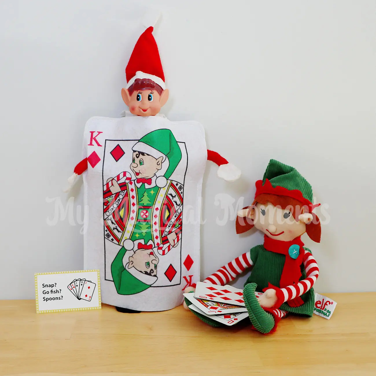 Elf wearing a king of diamonds card costume with an elf playing cards
