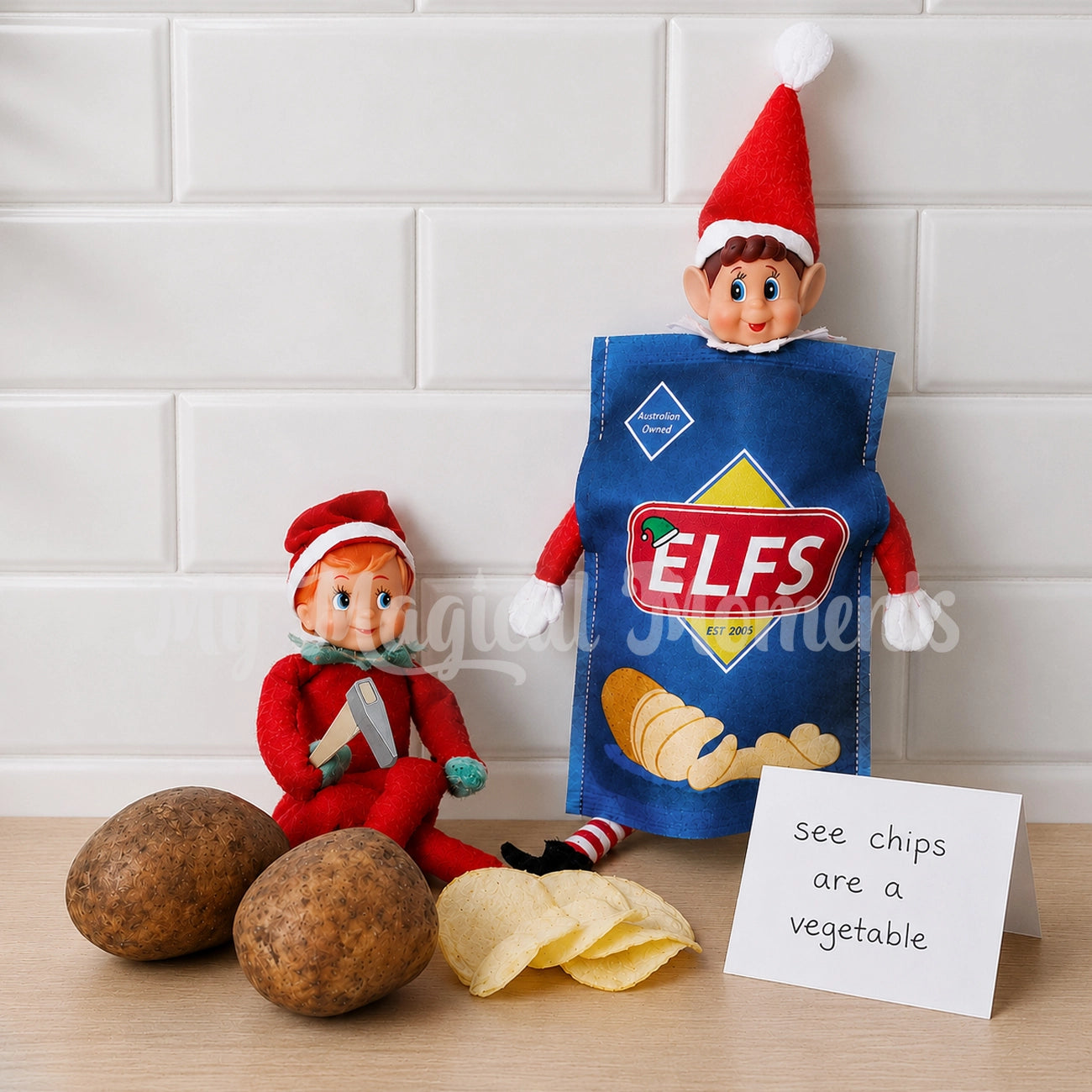 Elf cutting potato chips for elf dressed as chips