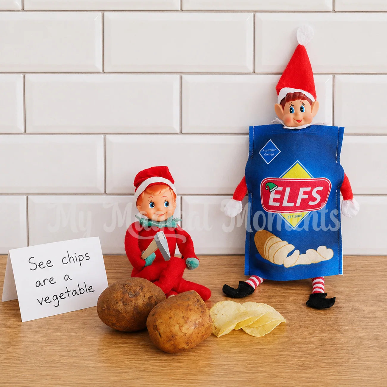Elf cutting potato chips for elf dressed as chips