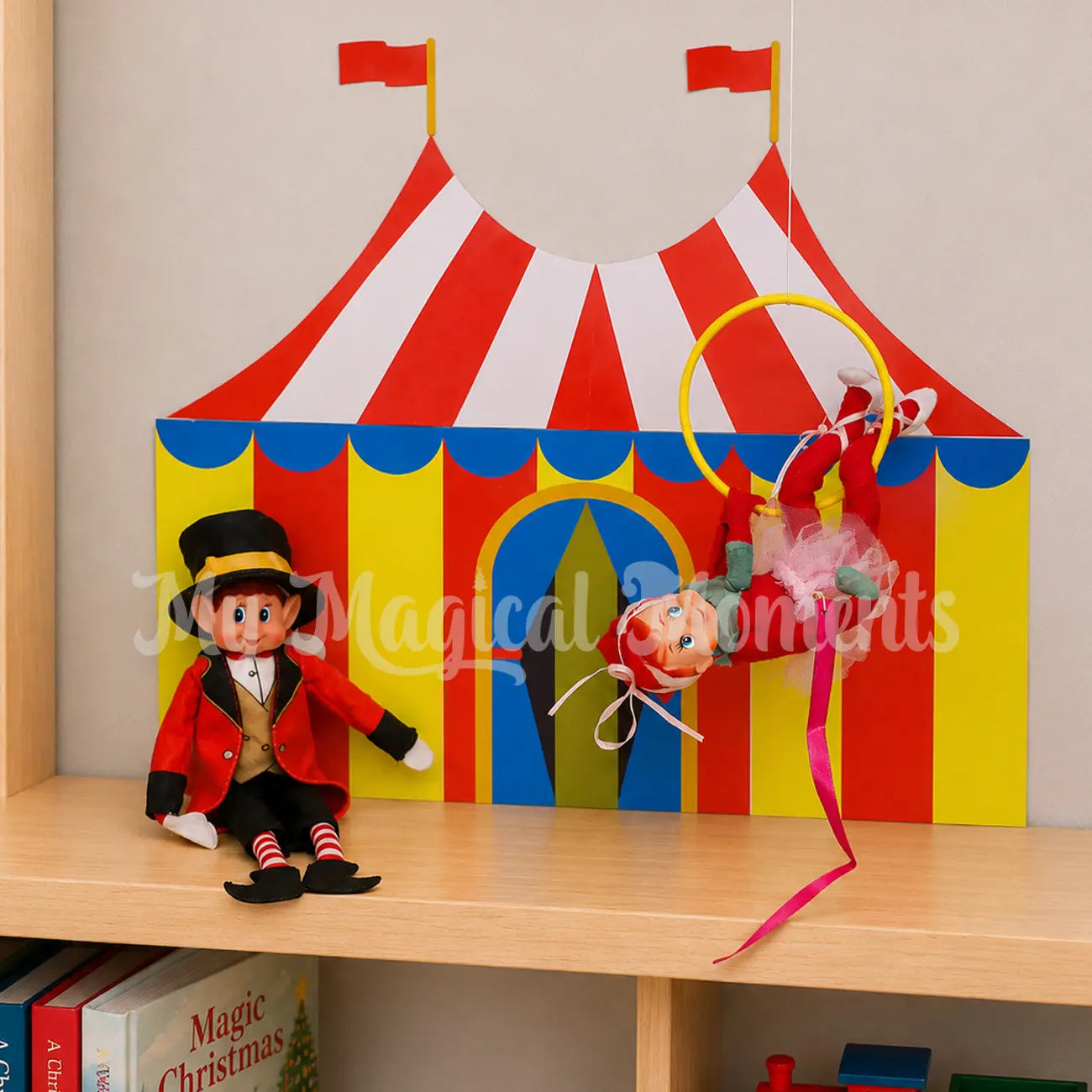 Circus Tent Printable With a Ballerina hanging in a hula hoop with an elf dressed as a circus ring leader
