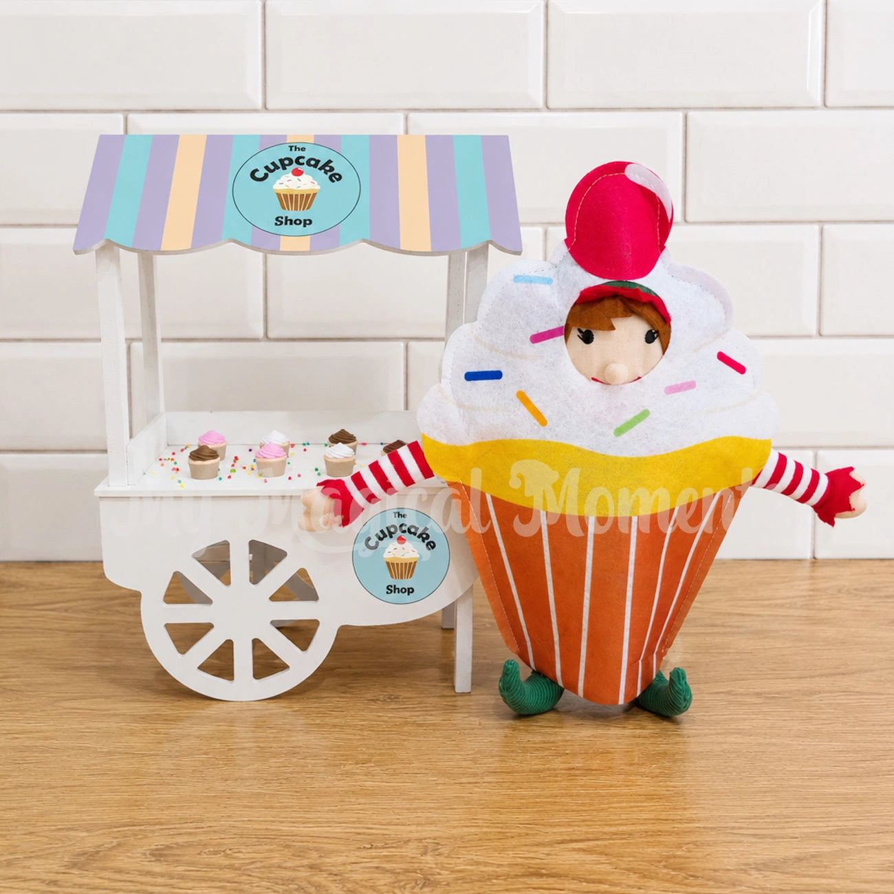 Elf dressed as a cupcake selling miniature cupcakes at her shop