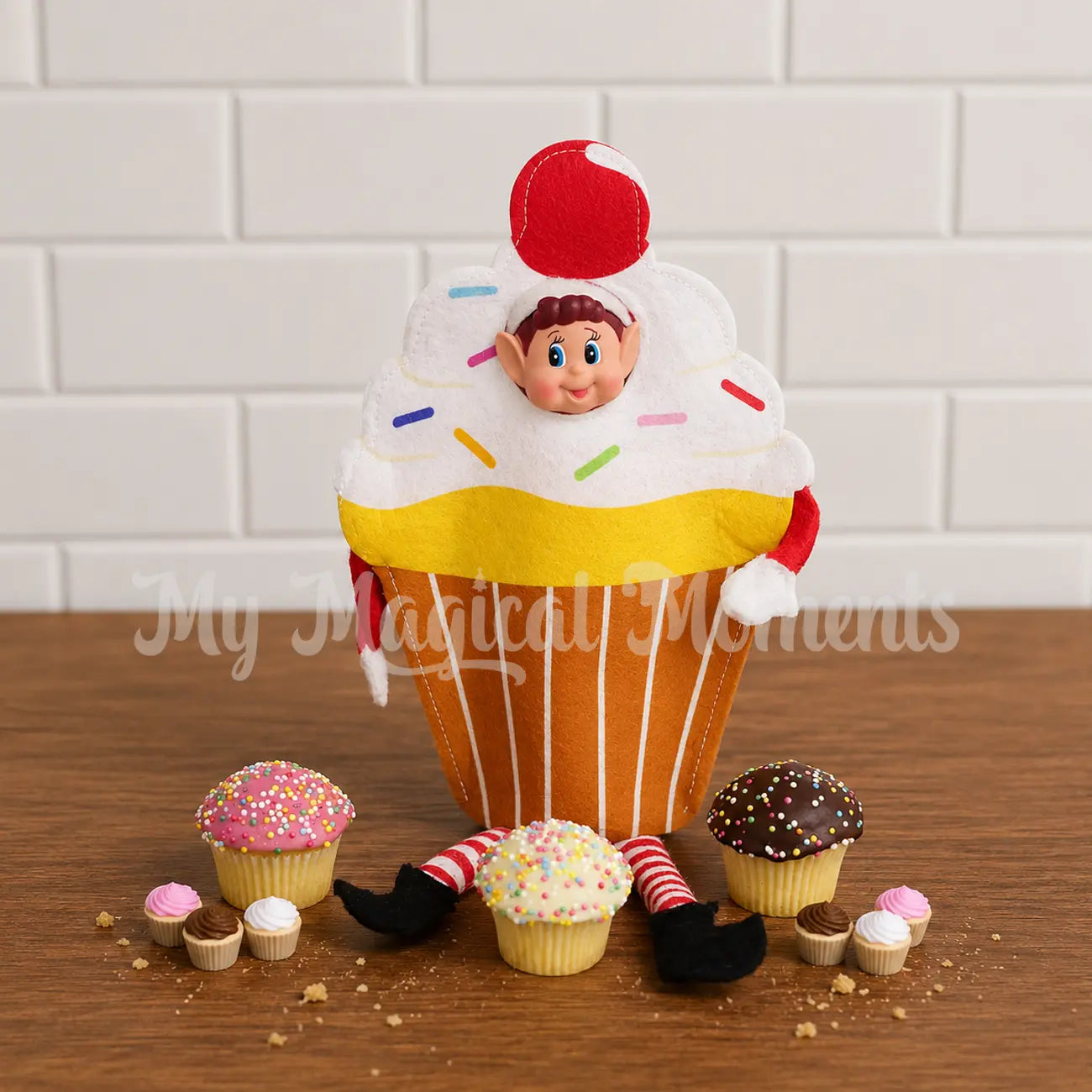 elf wearing a cupcake costume with mini elf cupcake props