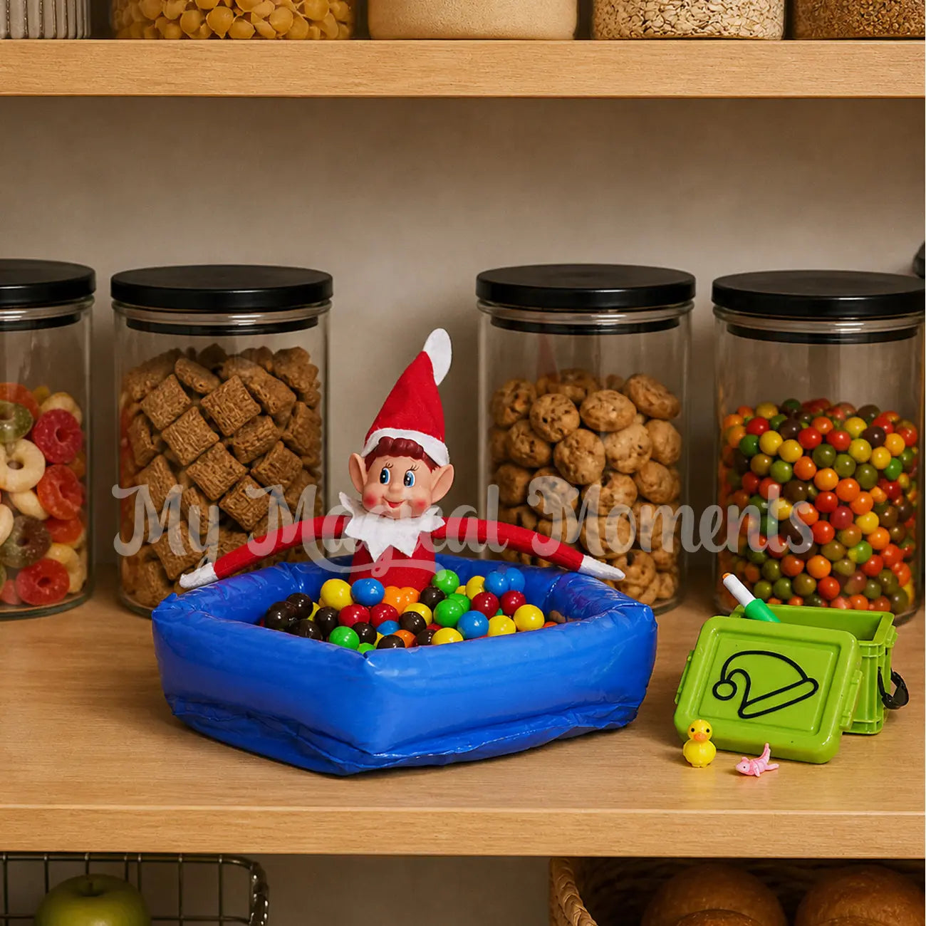 Elves behavin badly playing in an inflatable ball pit with m&ms and a small container with an axolotl fidget, a rubber duck and a water gun