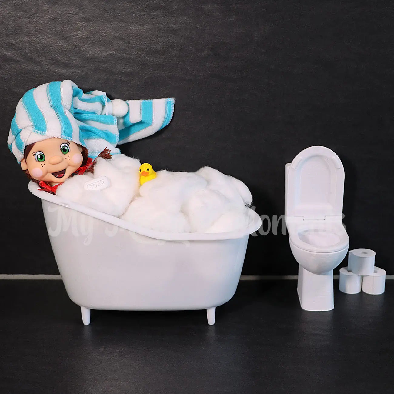 My Elf Friends Brown Hair Girl With A towel on her head having a bath with her rubber ducky, and bar of soap There is a mini toilet and toilet rolls