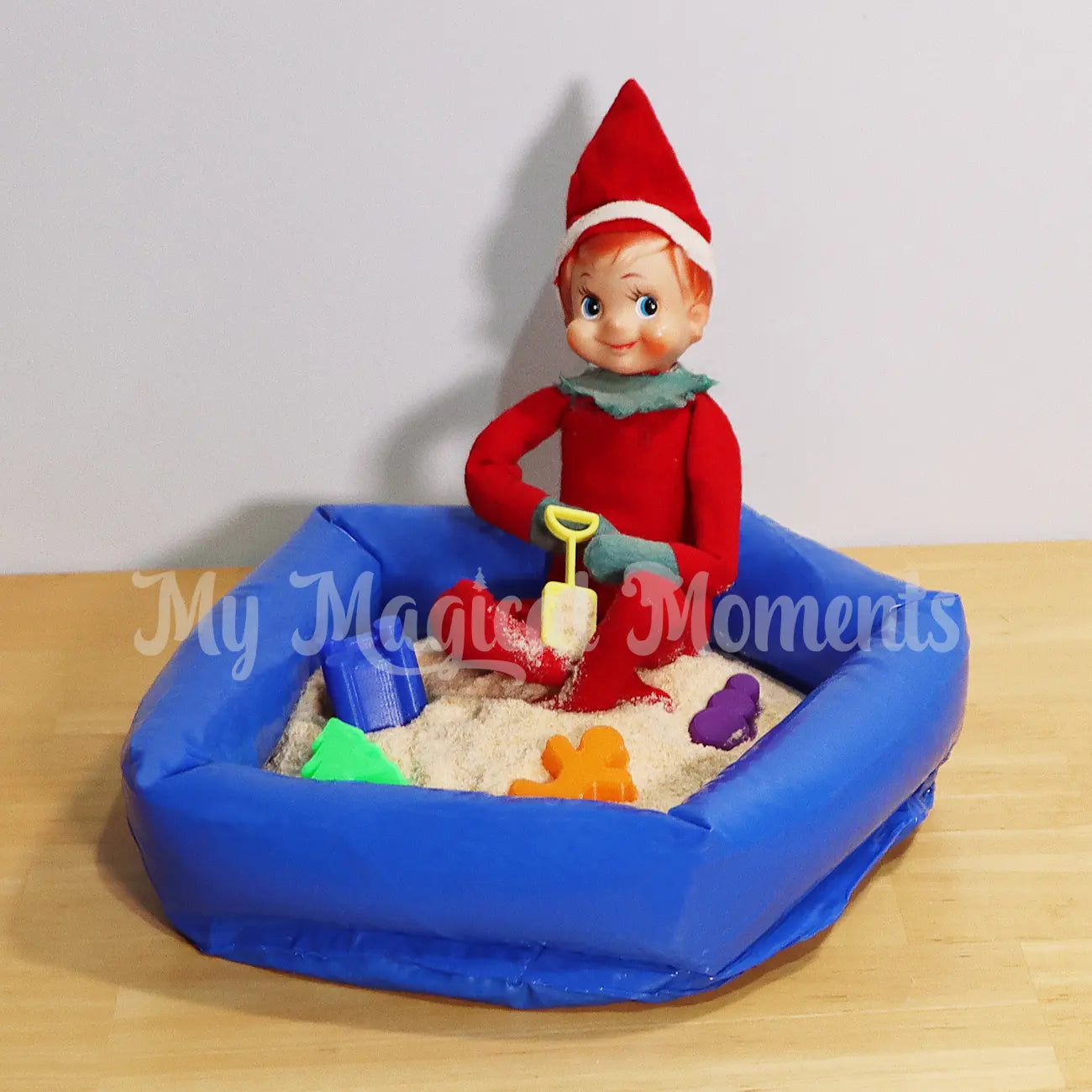 Elf playing in a mini sand pit with mini sand toys
