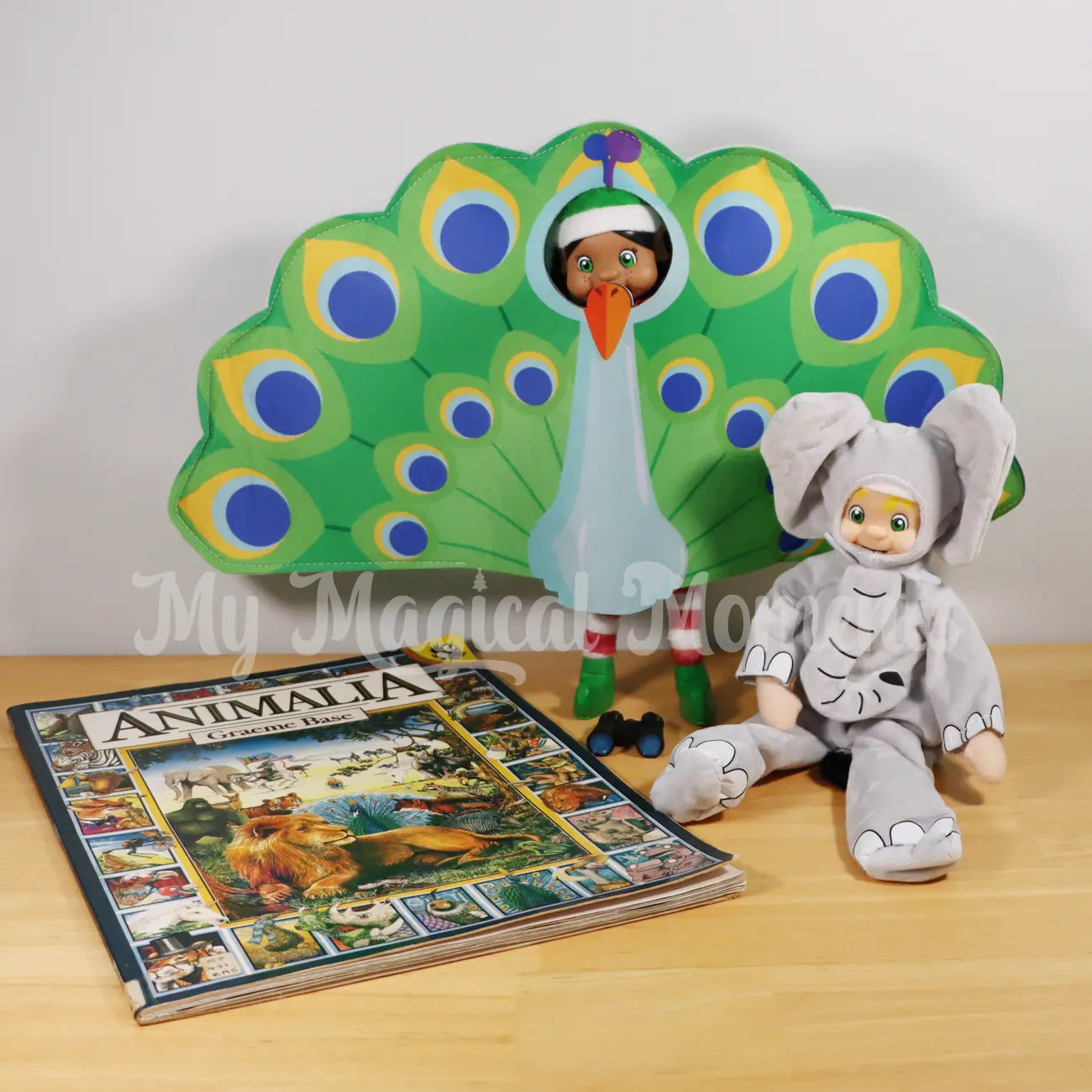 Black Hair Bendable Standing Elf Friends wearing a peacock costume, a blonde hair elf boy wearing an elephant costume with binoculars and a animalia book