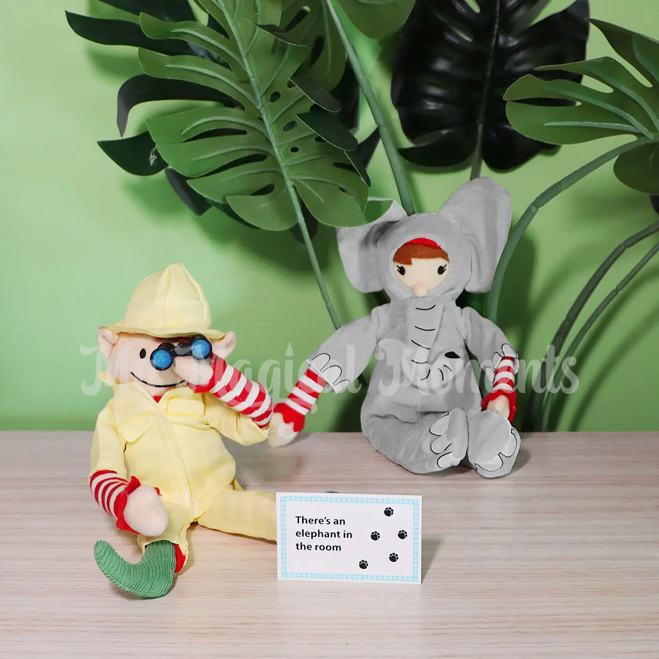 Elf for Christmas elves wearing an elephant dress up costume and a zoo keeper uniform holding mini elf binocular props