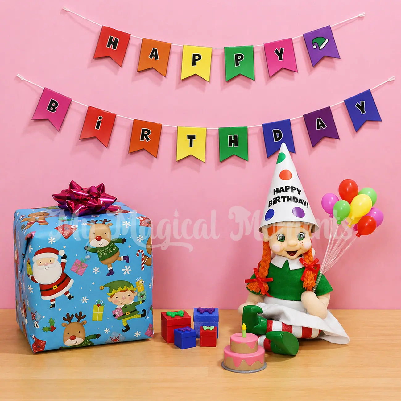 Orange hair My Elf Friends Bendable elf wearing a party hat, a bunch of balloons and a mini strawberry birthday cake. Tiny Presents and a birthday banner