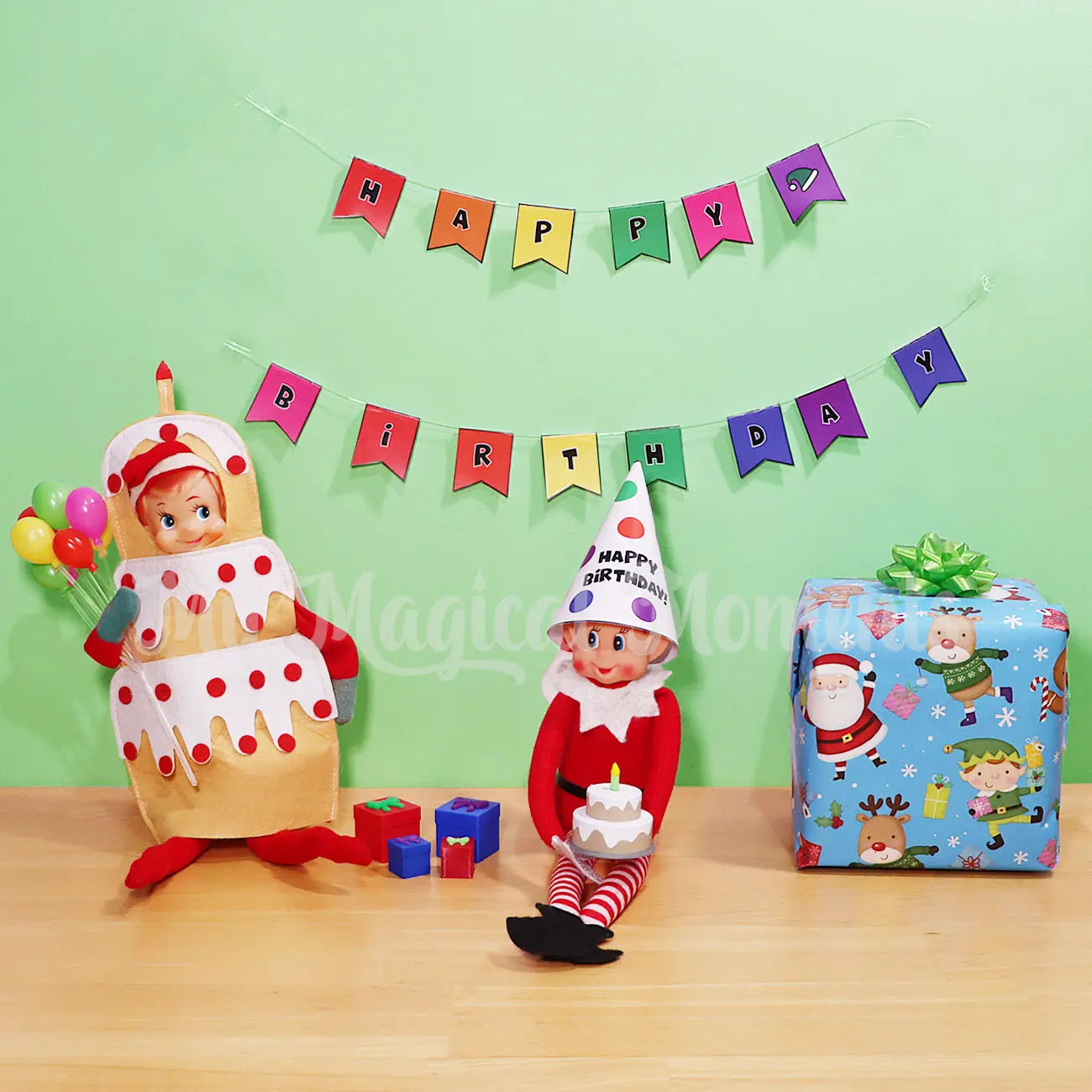 Elves behavin badly wearing a party hat printable, with elf shelf wearing a cake costume holding mini balloons. A Vanilla elf sized cake and presents With a happy birthday banner