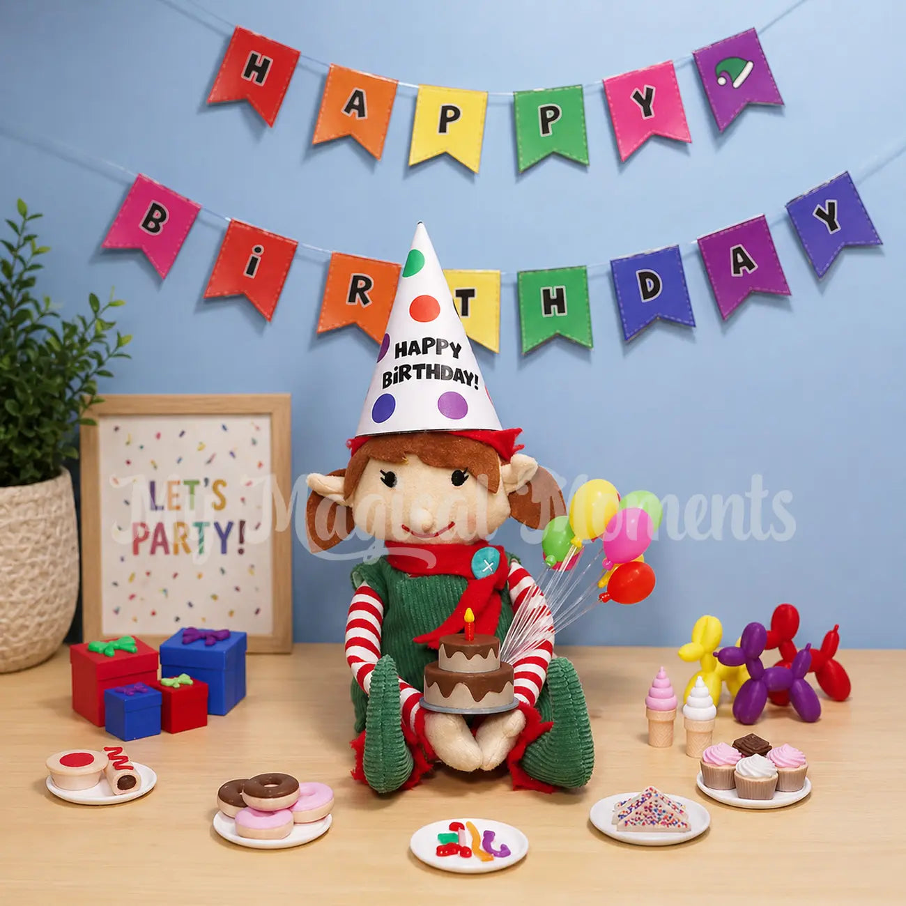 Elf For Christmas holding a mini chocolate Birthday Cake, with elf sized party food, Fairy bread, cupcakes, donuts, pie, sausage rolls soft serves, presents and balloon animals