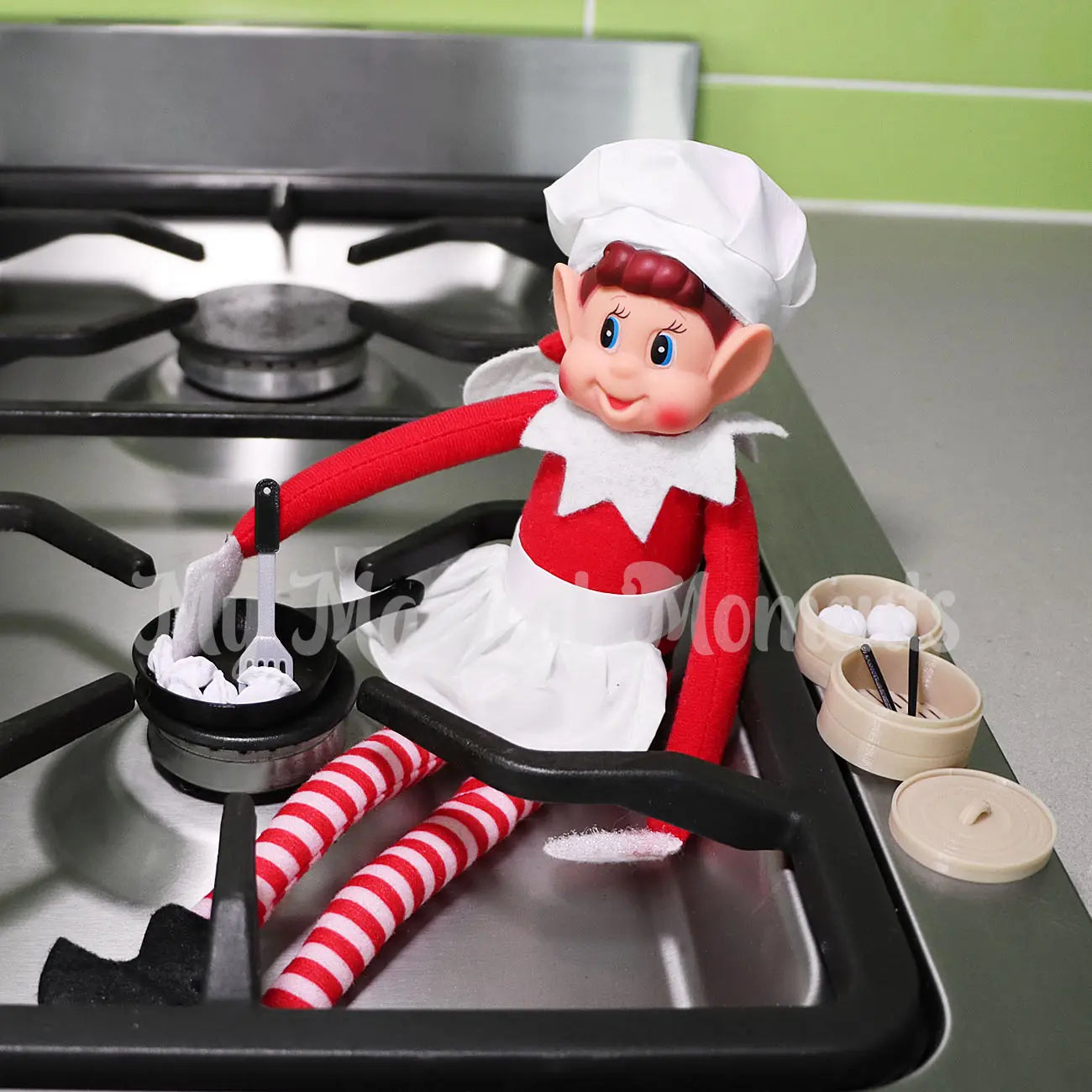 Elves Behavin Badly Wearing a chef costume making mini dumplings in a elf sized frying pan and spatula