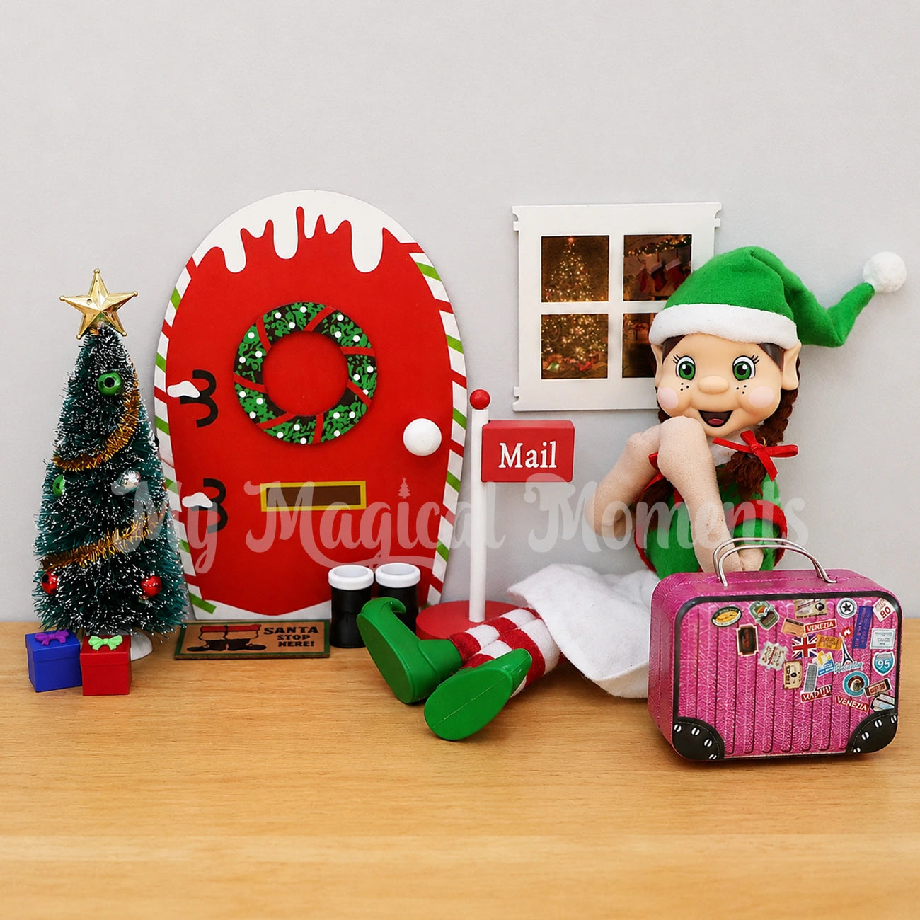 Brown hair Elf Arriving with a suitcase by an elf door, mini door mat, tree and presents