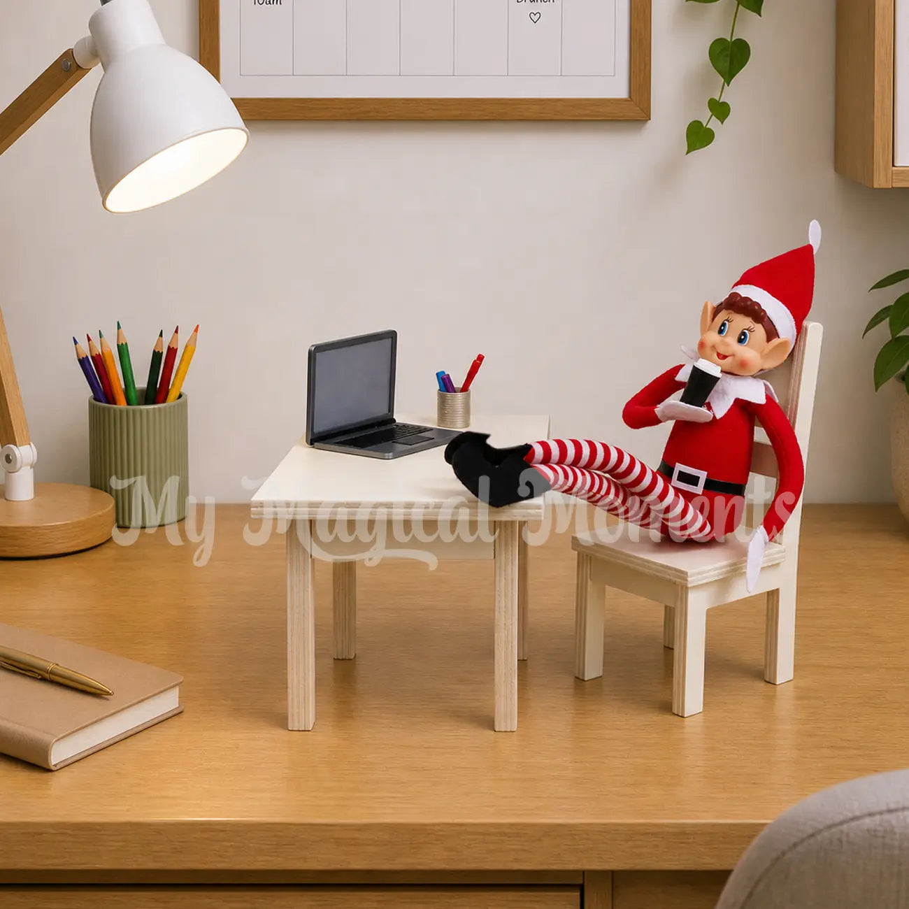Elf drinking coffee in the office with mini laptop prop, and elf accessories, sitting on a mini wooden dining table