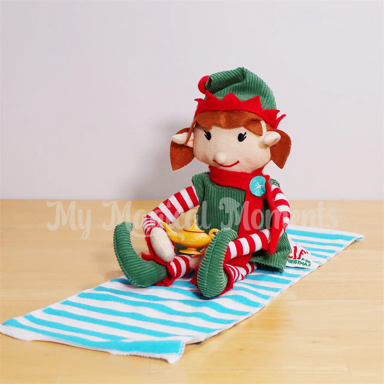 Elf for Christmas Rubbing a Magic Lamp on a flight carpet beach towel