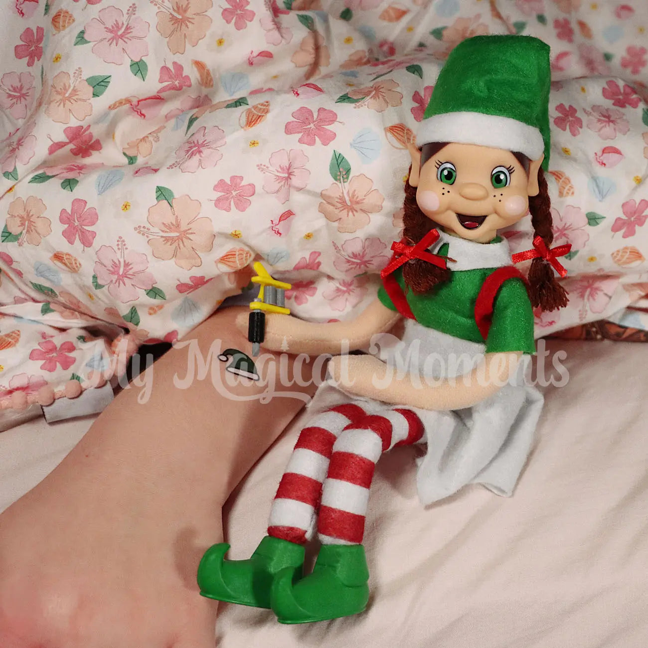 My Elf Friends Tattooing child sleeping with a temporary Christmas tattoo