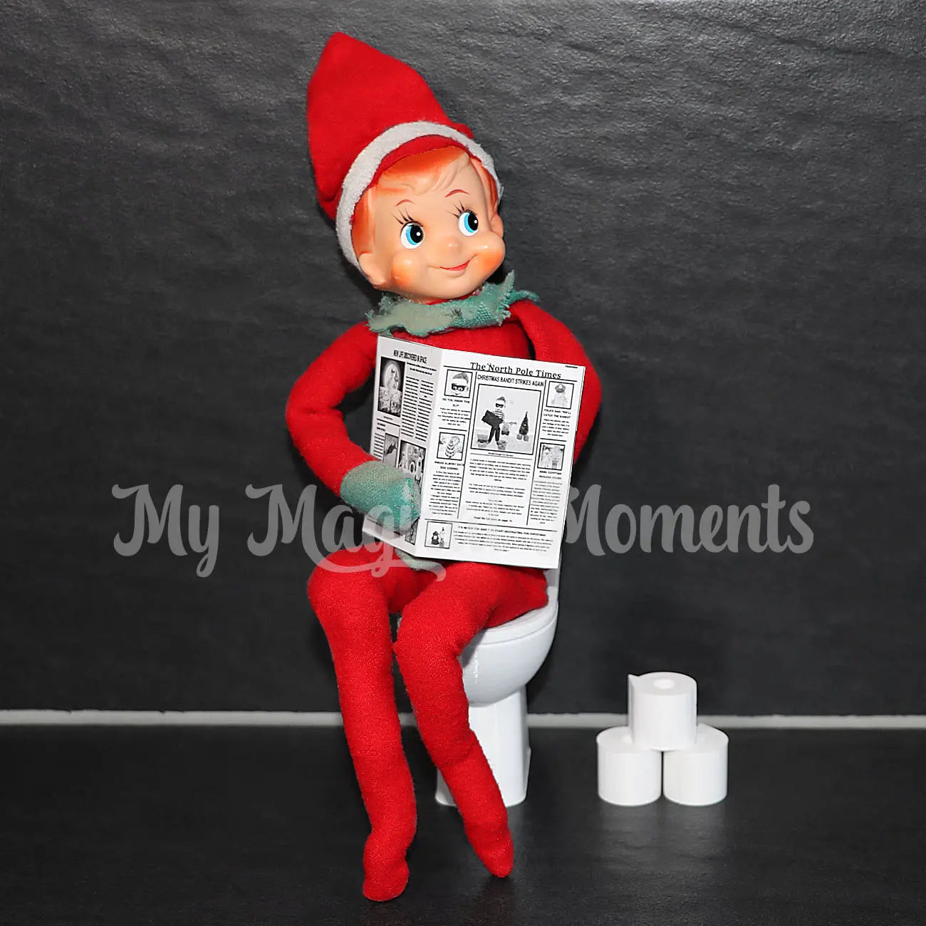 Elf on the Shelf sitting on a toilet reading a newspaper against a dark background