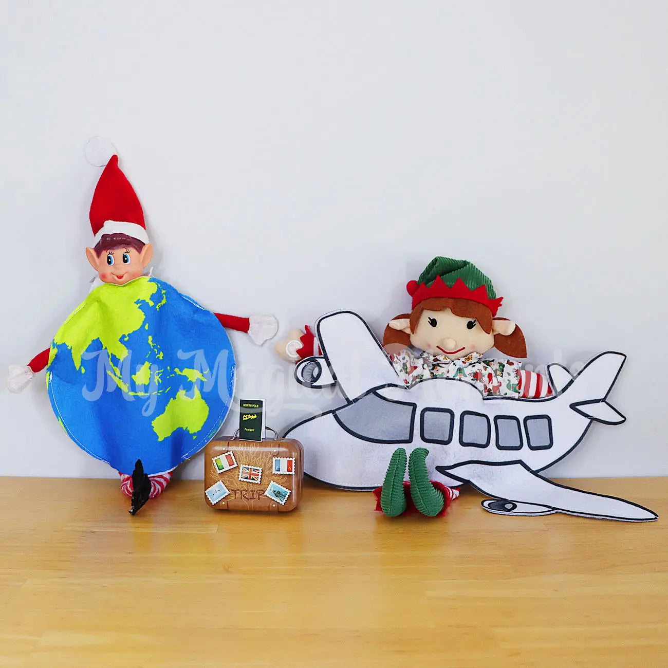 Elf wearing a world map costume with another elf wearing a plane costume, Hawaiian shirt and suitcase
