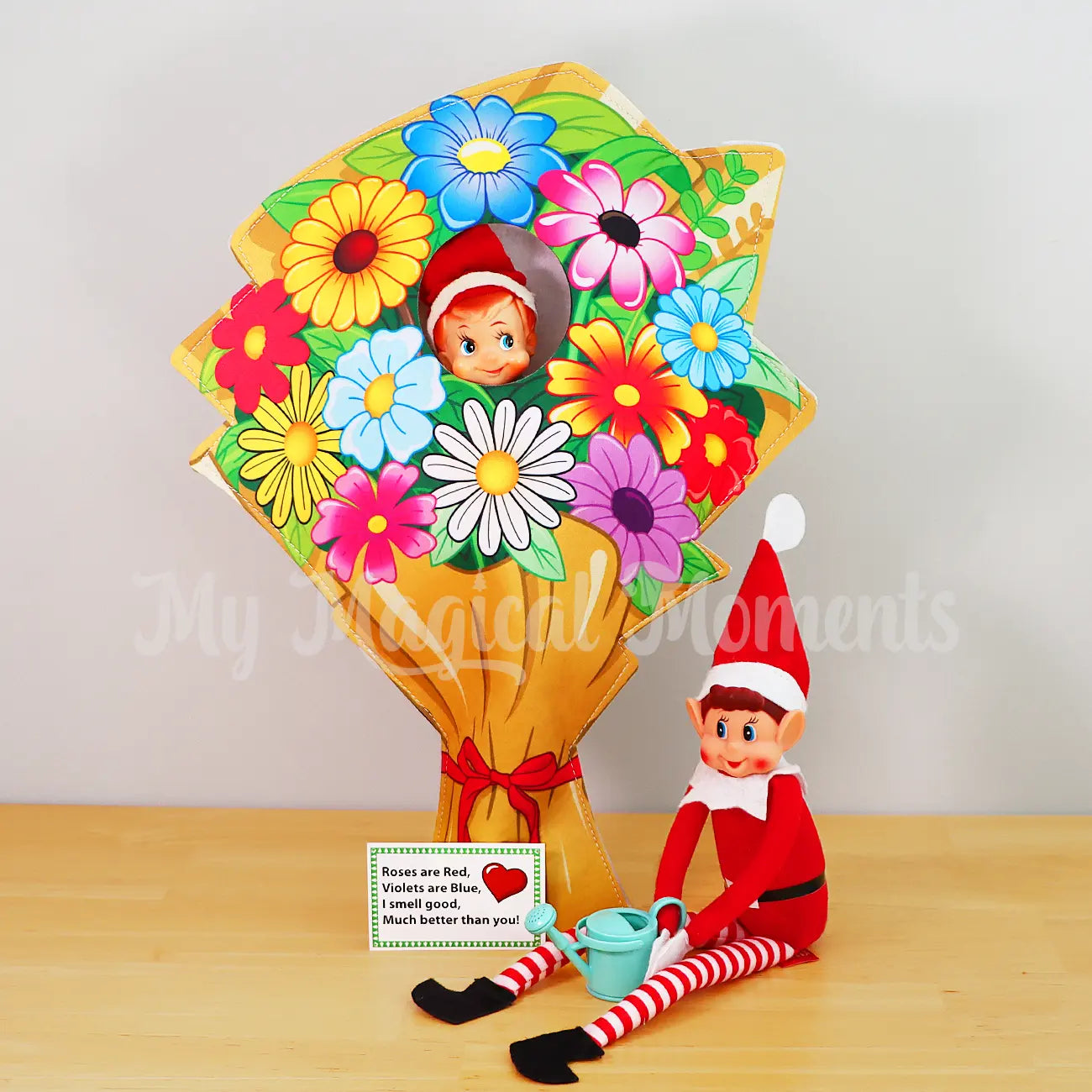 elf shelf wearing a flowers costume with elves behavin badly using a watering can on the bouquet