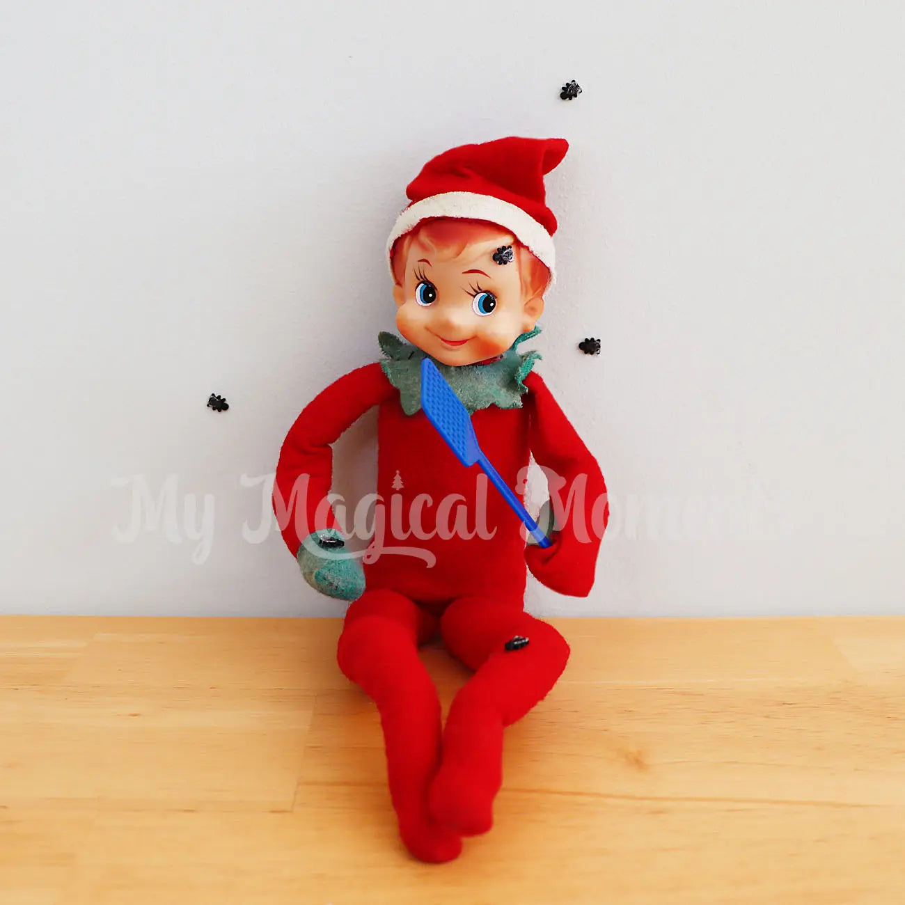 elf with a mini fly swatter and flies