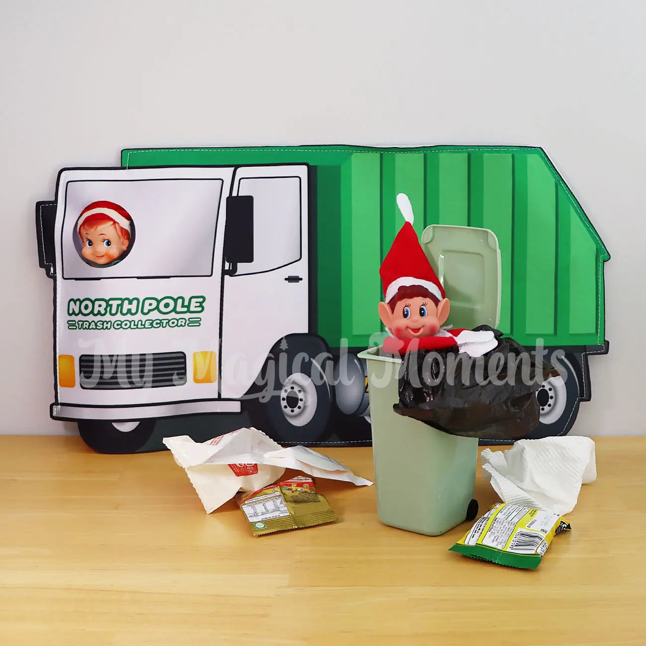 Elf in a mini bin prop with an elf wearing a garbage truck costume