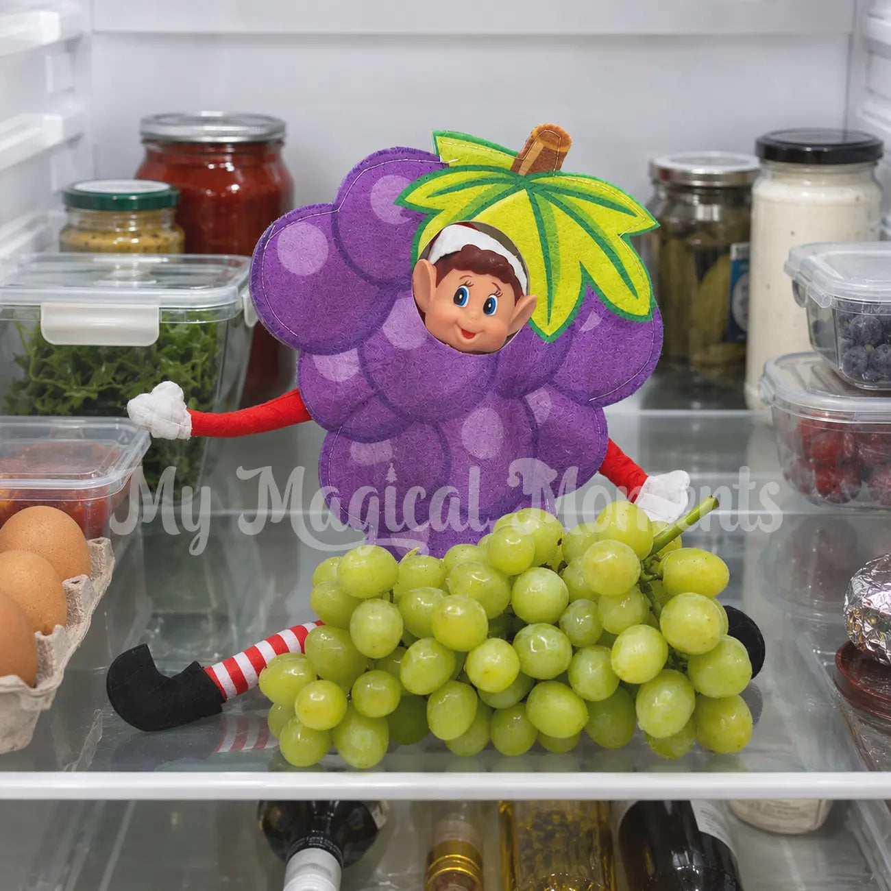 Elves behavin badly elf wearing a grape costume with grapes in a fridge