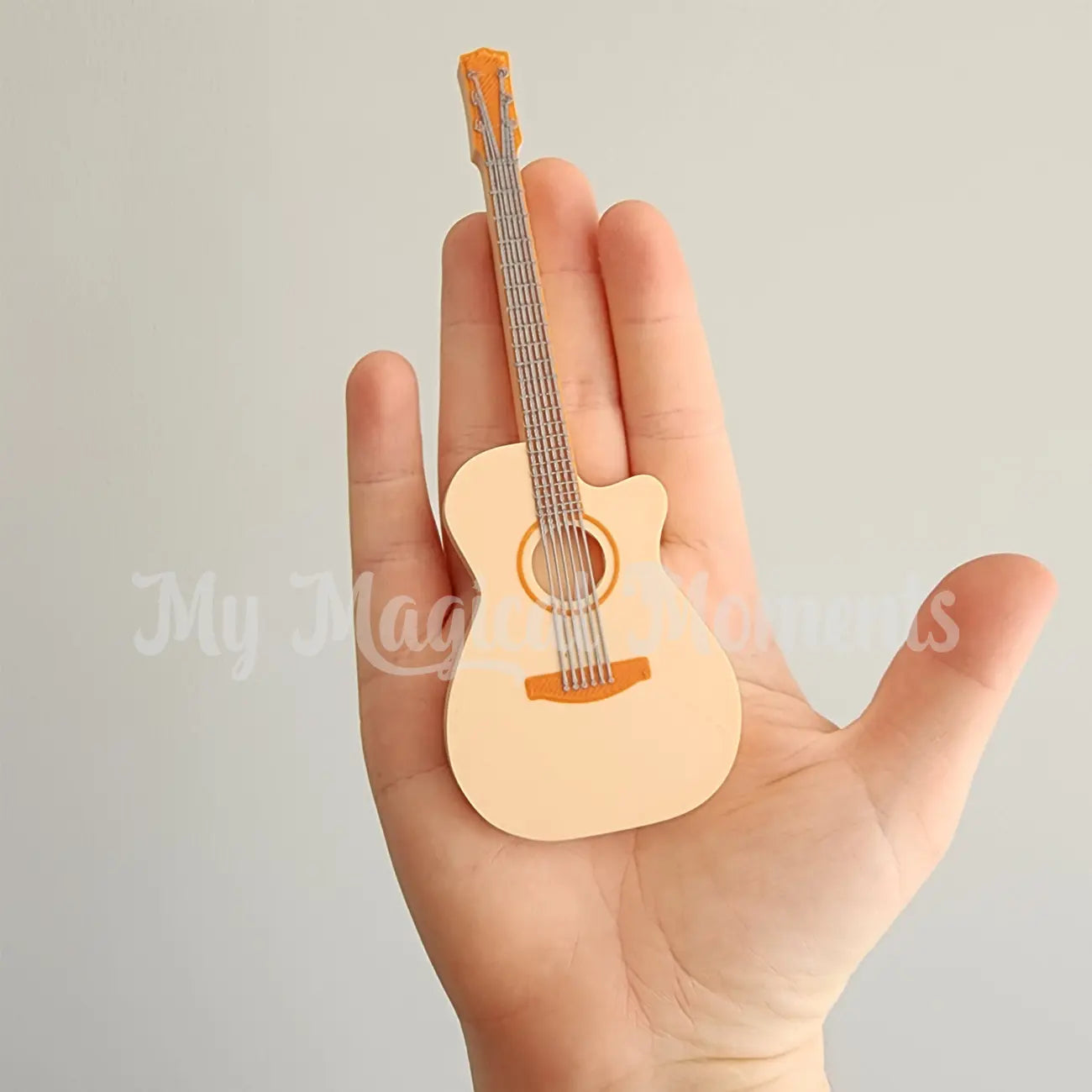 Miniature 3d printed guitar comparison to human hands