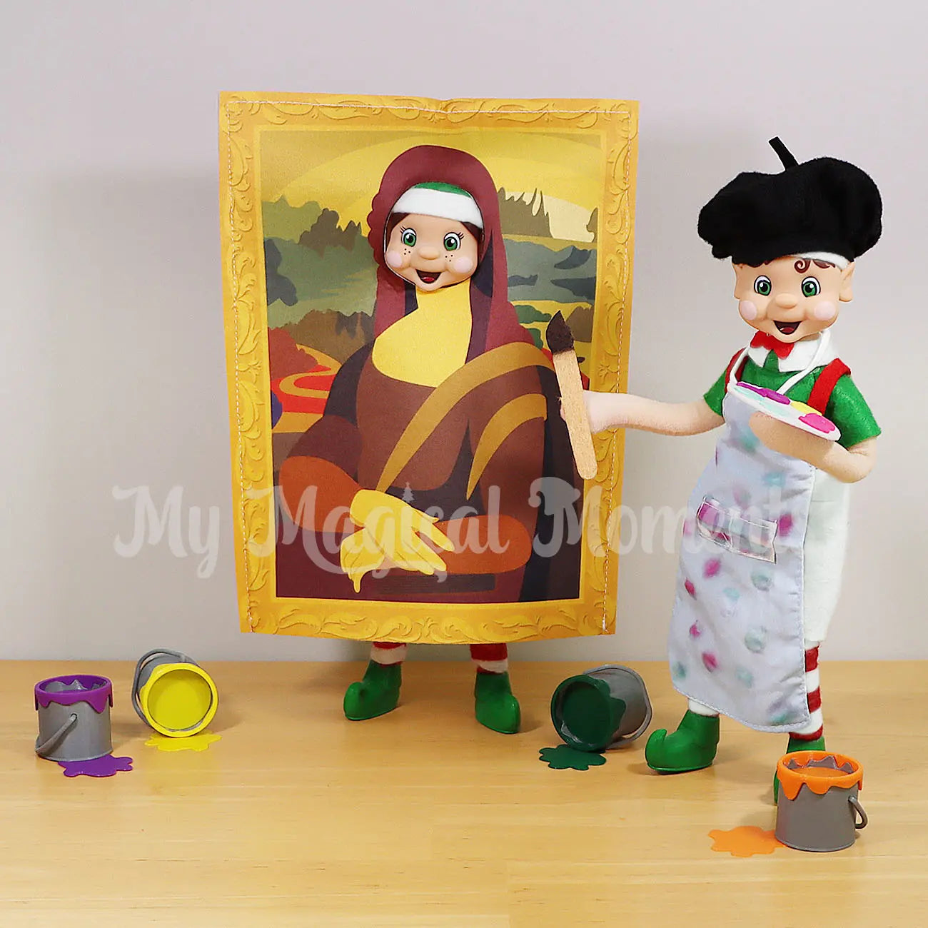 Elf Wearing A Mona List Costume in a frame with an elf wearing an artist outfit. Using mini elf paints