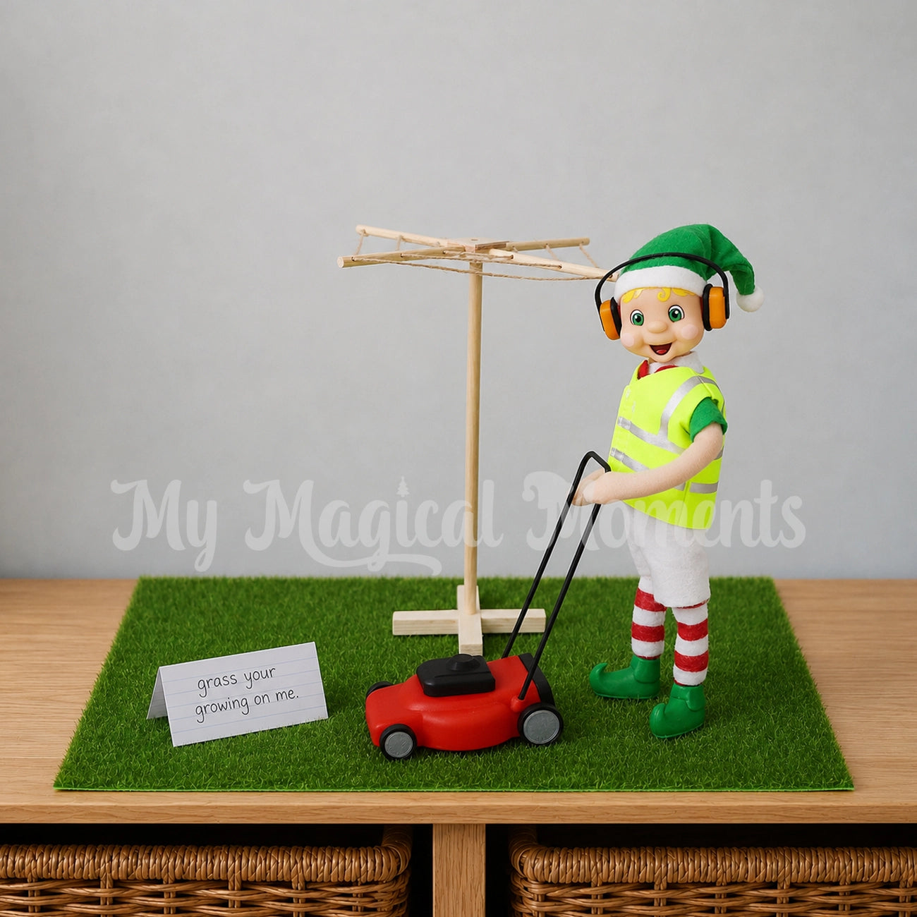 Blonde Hair My Elf Friend Elf Mowing a patch of grass with an elf sized lawn mower and a clothesline