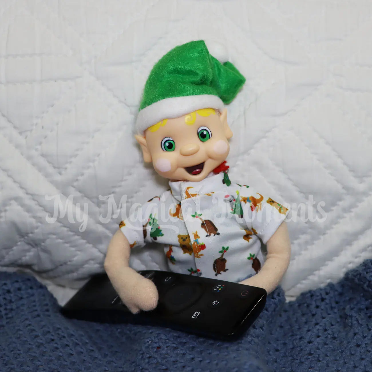 My Elf friends wearing mini Australian themed pjs sitting in bed with a remote