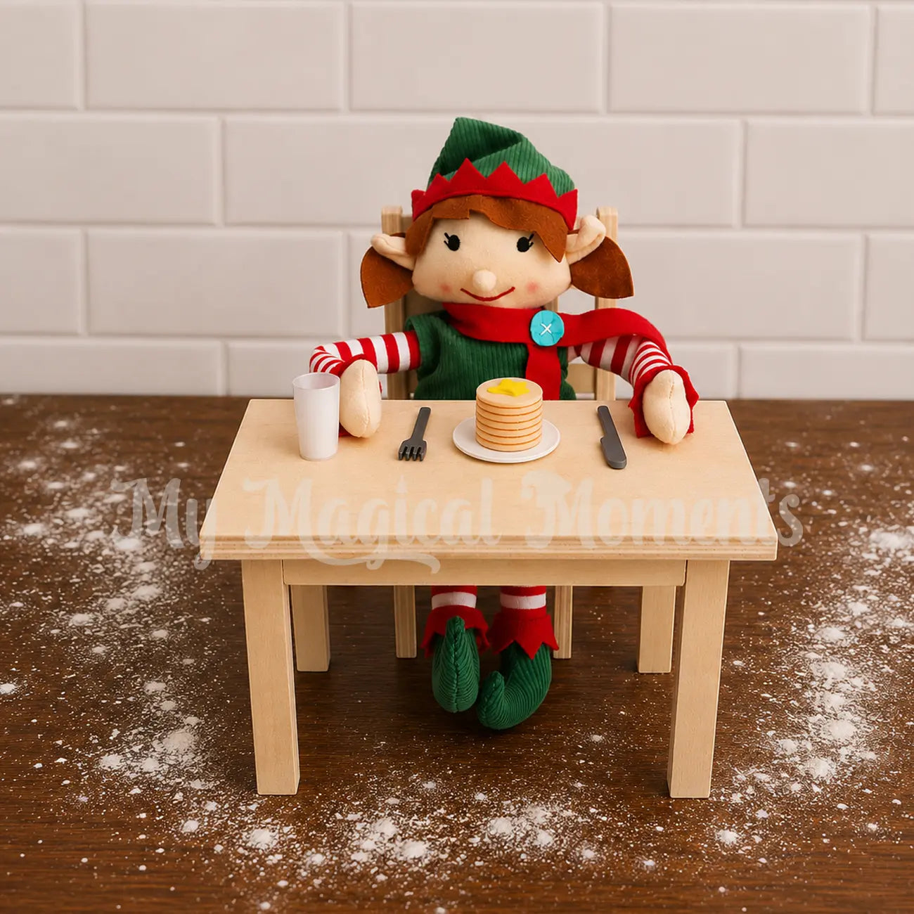 Elf eating a pancake stack with elf sized utensils on a mini wooden table