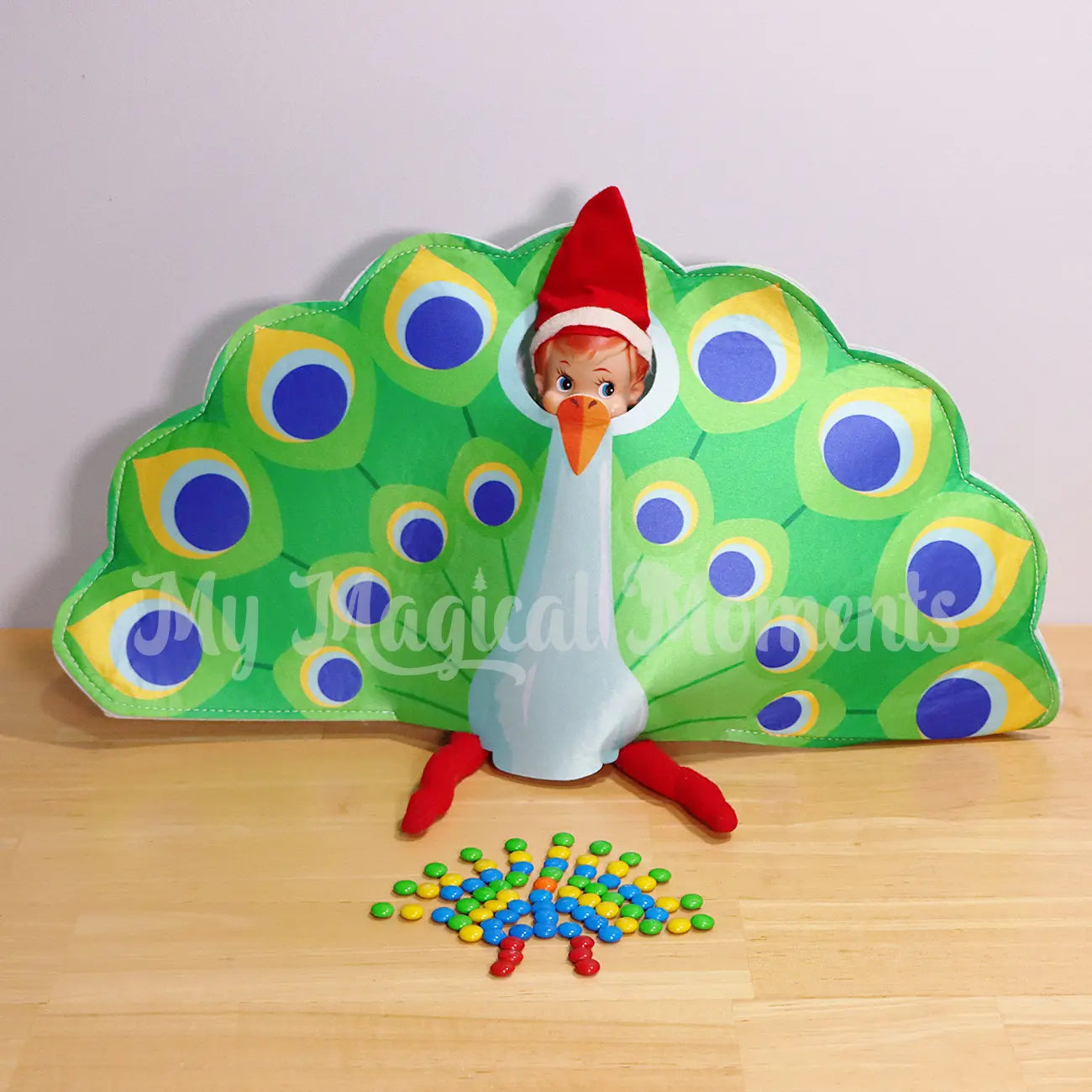 Elf Shelf Wearing a peacock outfit with M&m peacock picture