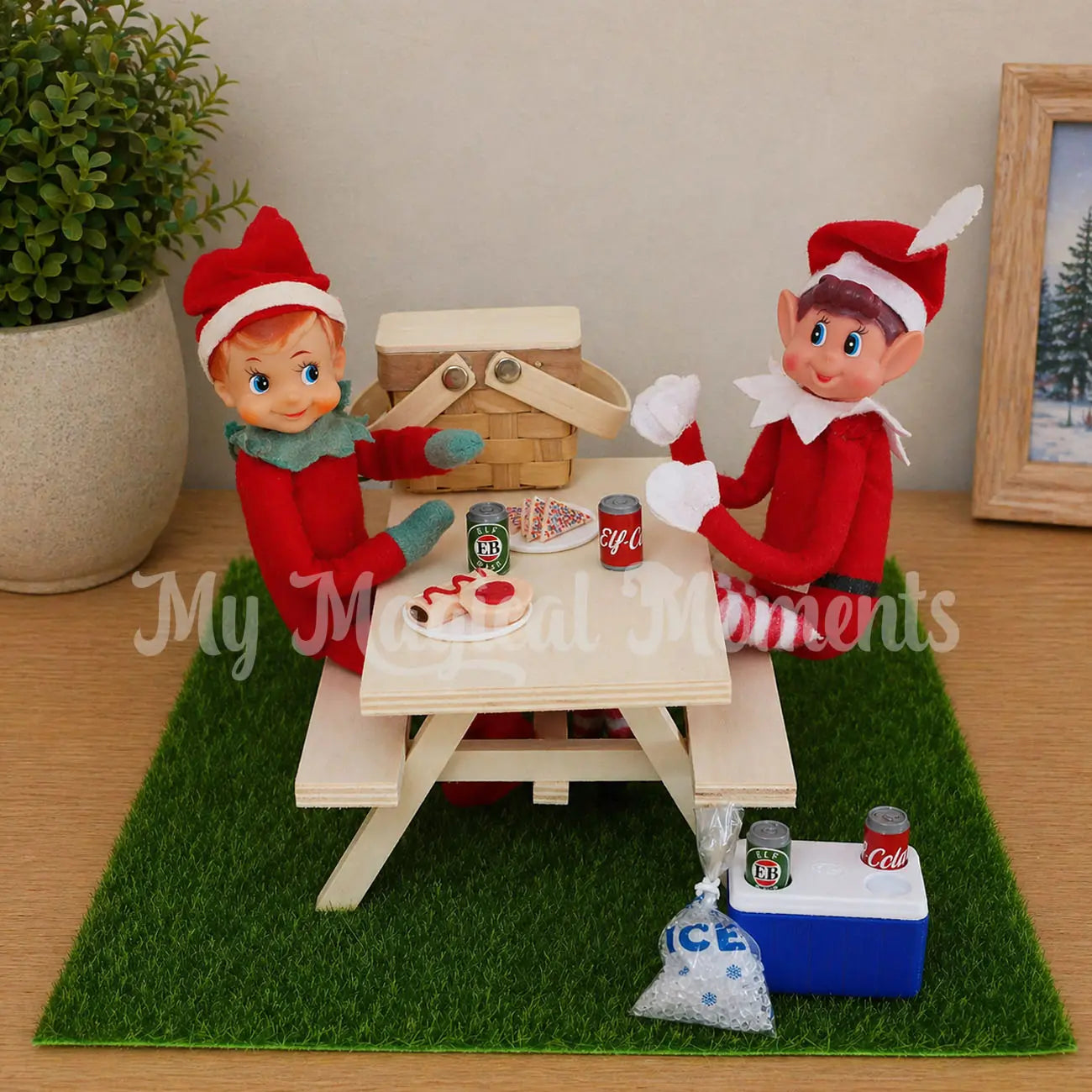 Elf having a picnic under the Christmas tree, with picnic basket and mini cola and beer