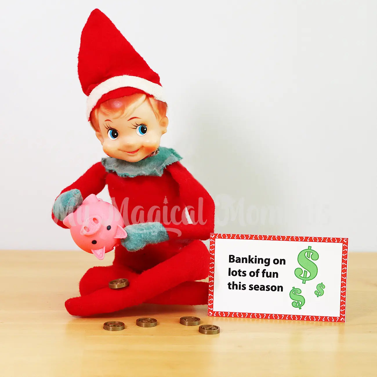 Elf Sitting shaking out mini coins from a piggy bank