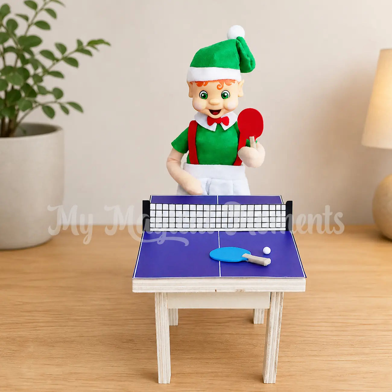 elf playing with a miniature ping pong table