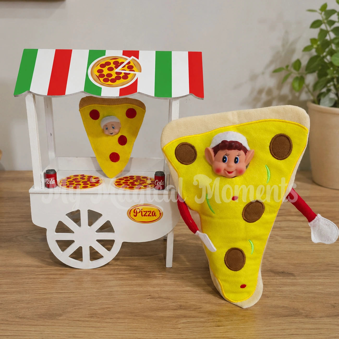 Elf dressed as a pizza selling pizza with an elf baby wearing a pepperoni pie outfit