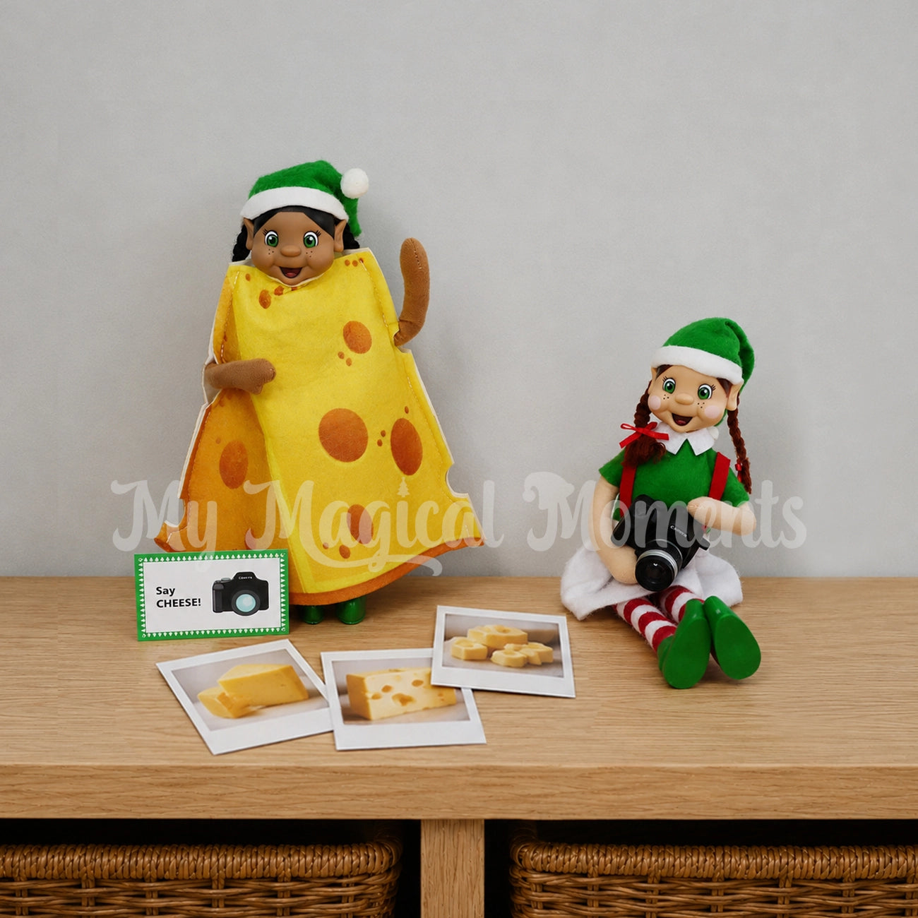 Elf wearing a cheese outfit with another elf holding a mini camera saying CHEESE