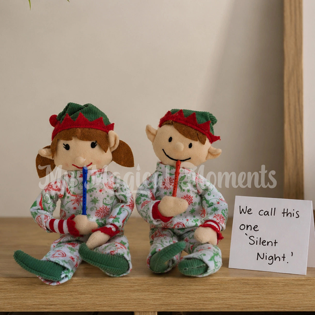 Elf For Christmas elves, wearing Christmas pjs, playing a little recorder prop with a sign saying we call this one SILENT NIght