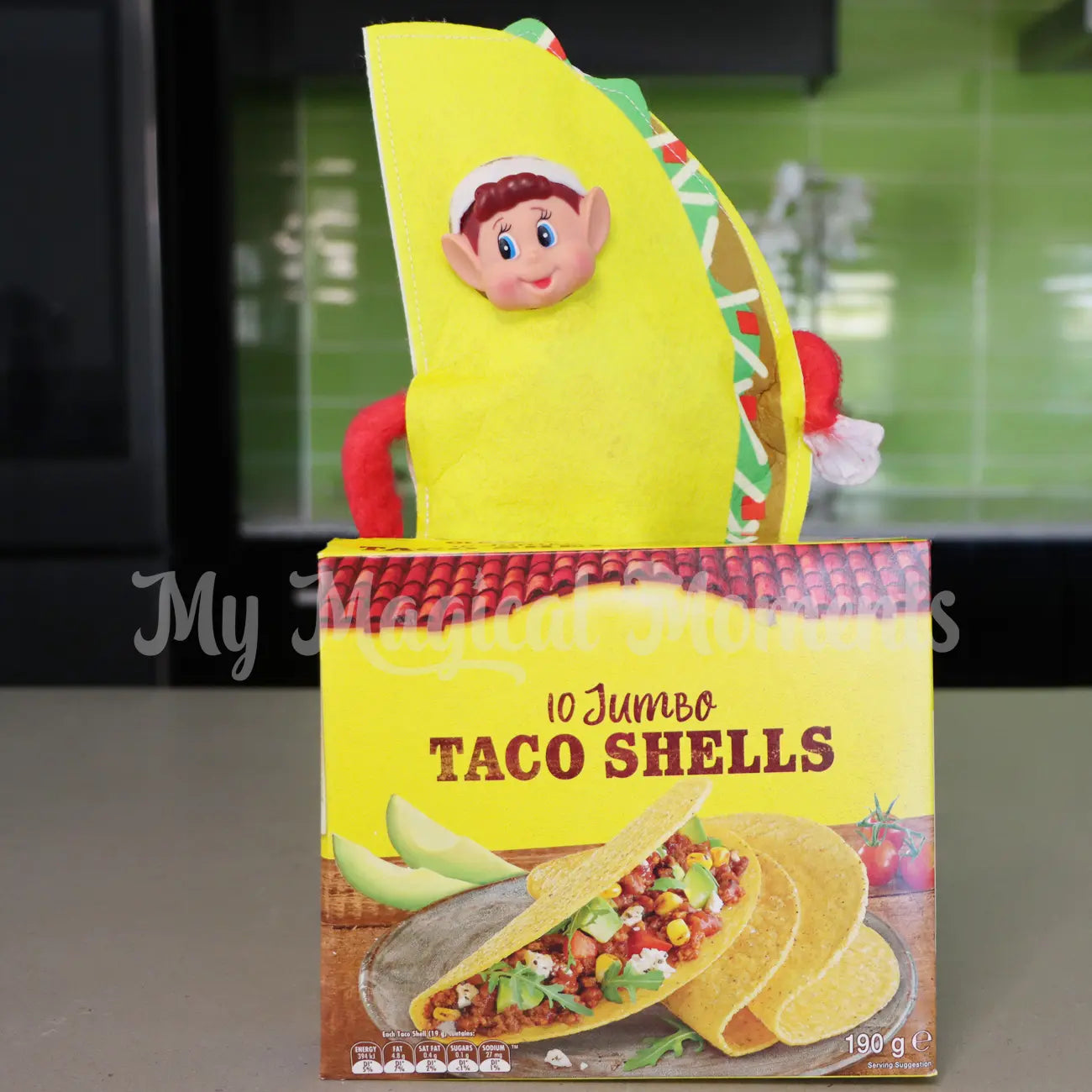 Elf wearing a taco outfit in a box of taco
