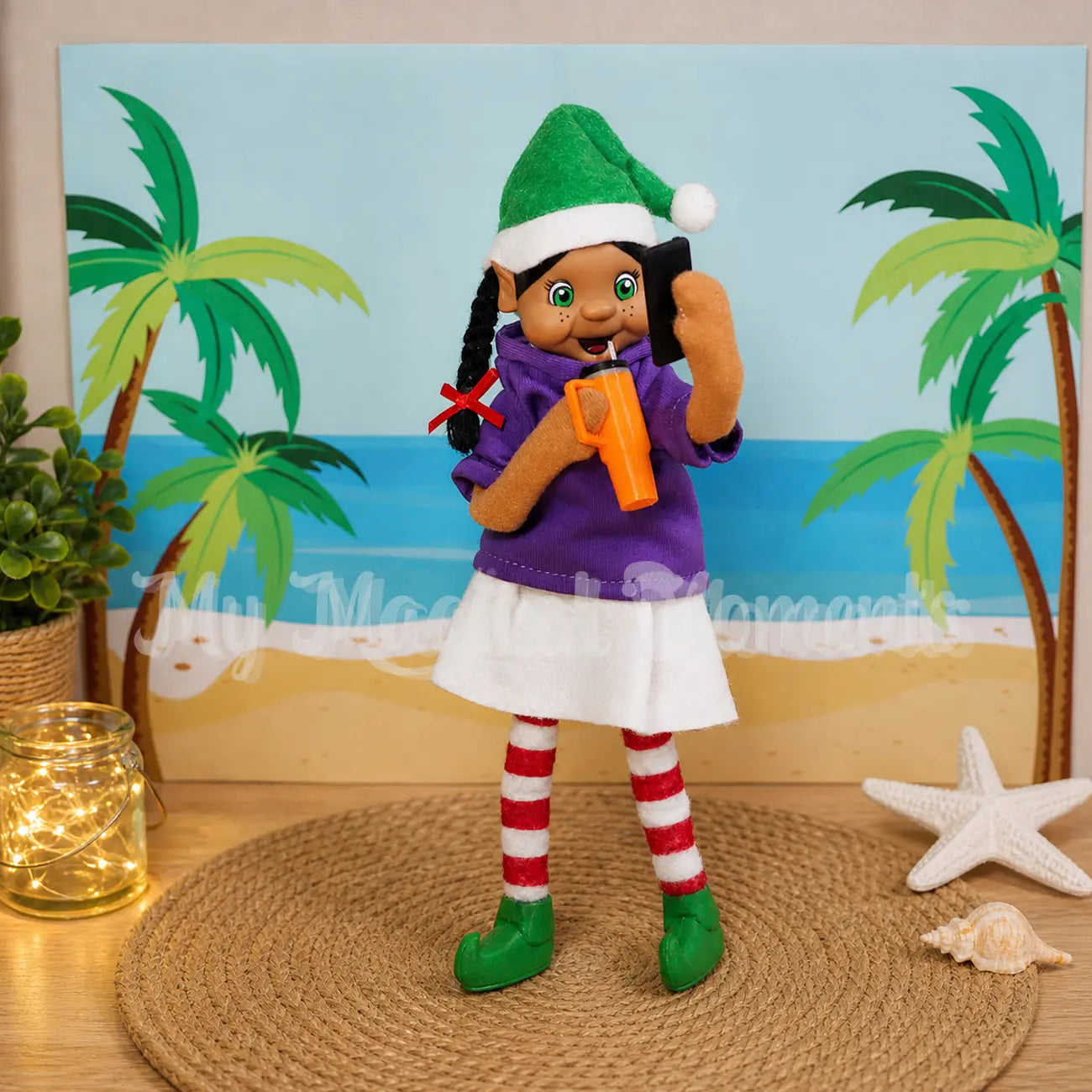 Black Hair standing Elf wearing a purple shirt taking a selfie with a mini mobile phone and with a beach background