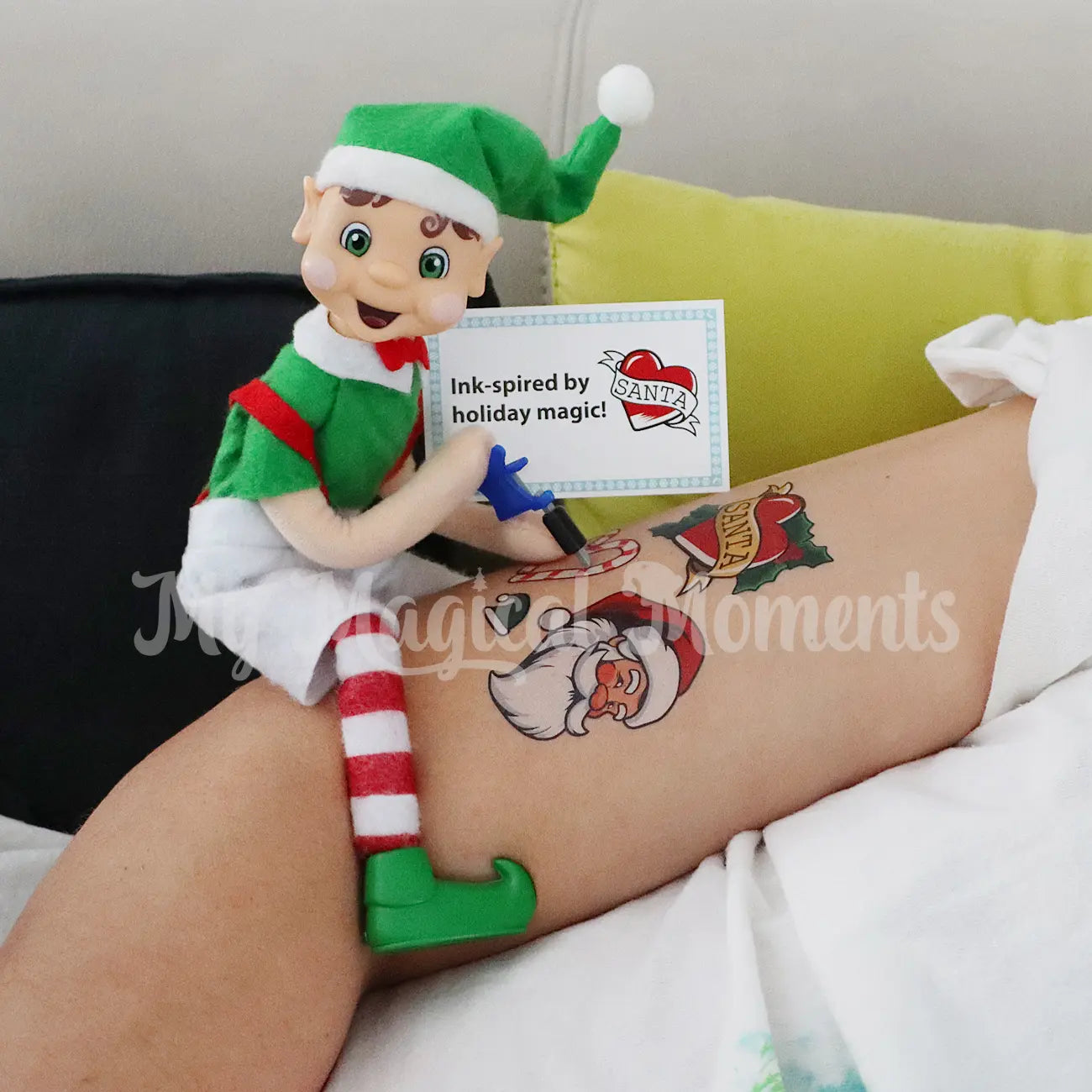 Elf Tattooing Dad with a mini Elf Gun and temporary Christmas themed tattoos
