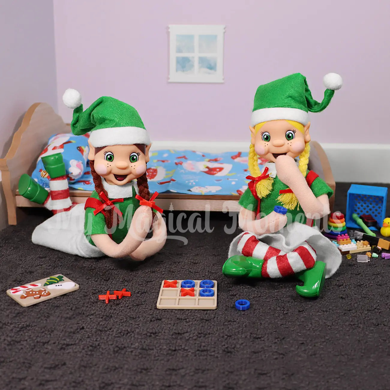Bendable Elves playing Tic Tac Toe prop in a bedroom with a mini wooden bed, puzzles, mini elf props