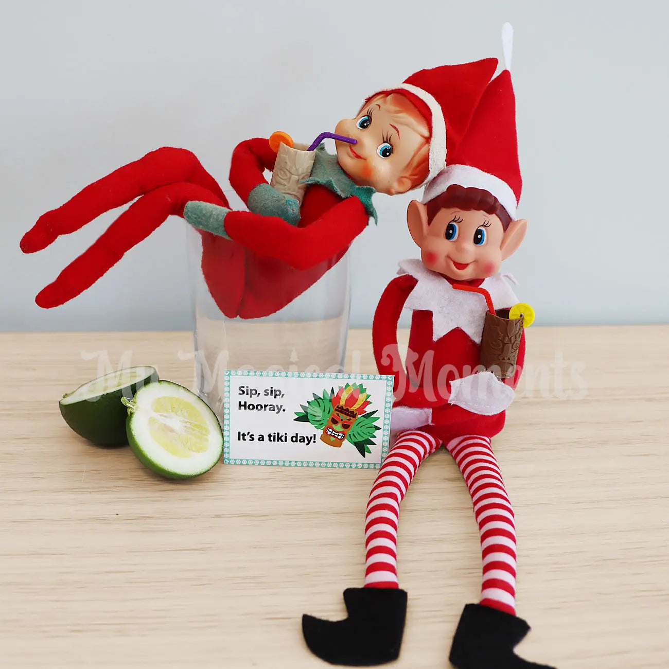 Elves having a cocktail in a glass with lime drinking from miniature tiki cup elf props
