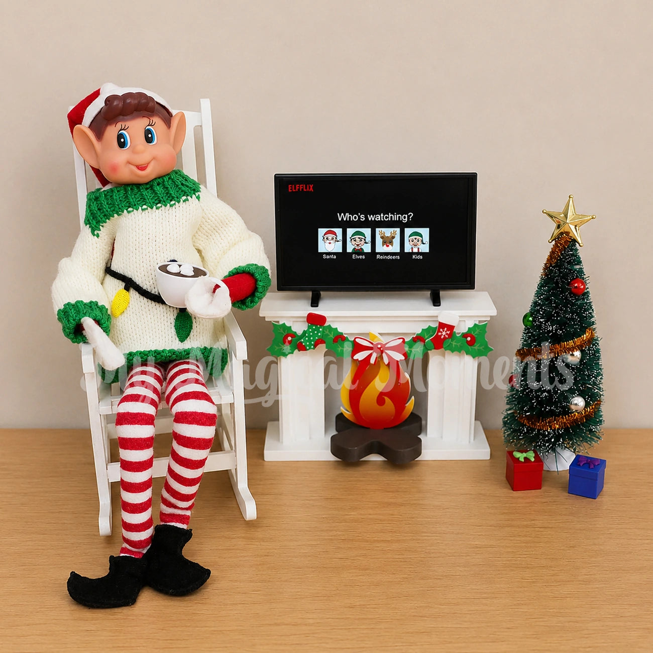 Ugly Sweater on an elf drinking hot cocoa with a fireplace and tree scene. Mini Elf tv